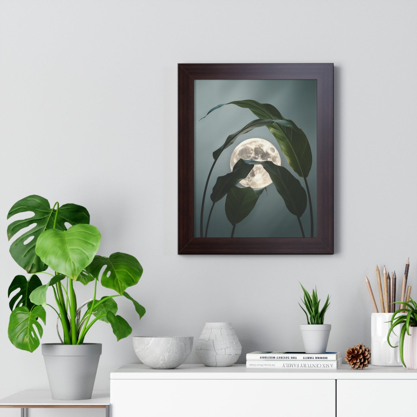 Vertical Moon and Tropical Leaves Poster features a luminous full moon with emerald leaves, capturing nature's serenity. Ideal for creating a peaceful ambiance, suitable for gifting. Available in various sizes.