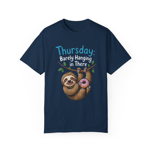 Thursday: Barely Hanging In There Sloth Graphic Comfort Colors Unisex T-Shirt features a cartoon sloth holding a donut, ideal for a relaxed, motivational vibe.