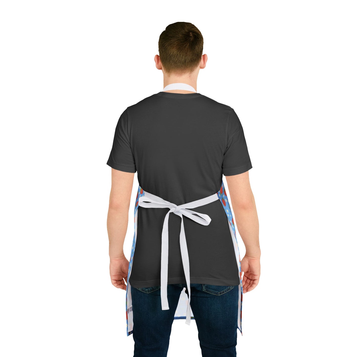 Man wearing Apron, Strawberry 5-Color Straps, focusing on vibrant, stain-free polyester canvas, ideal for cooking or crafting. His hand adjusts the tie-back closure, showcasing the apron’s practical design.