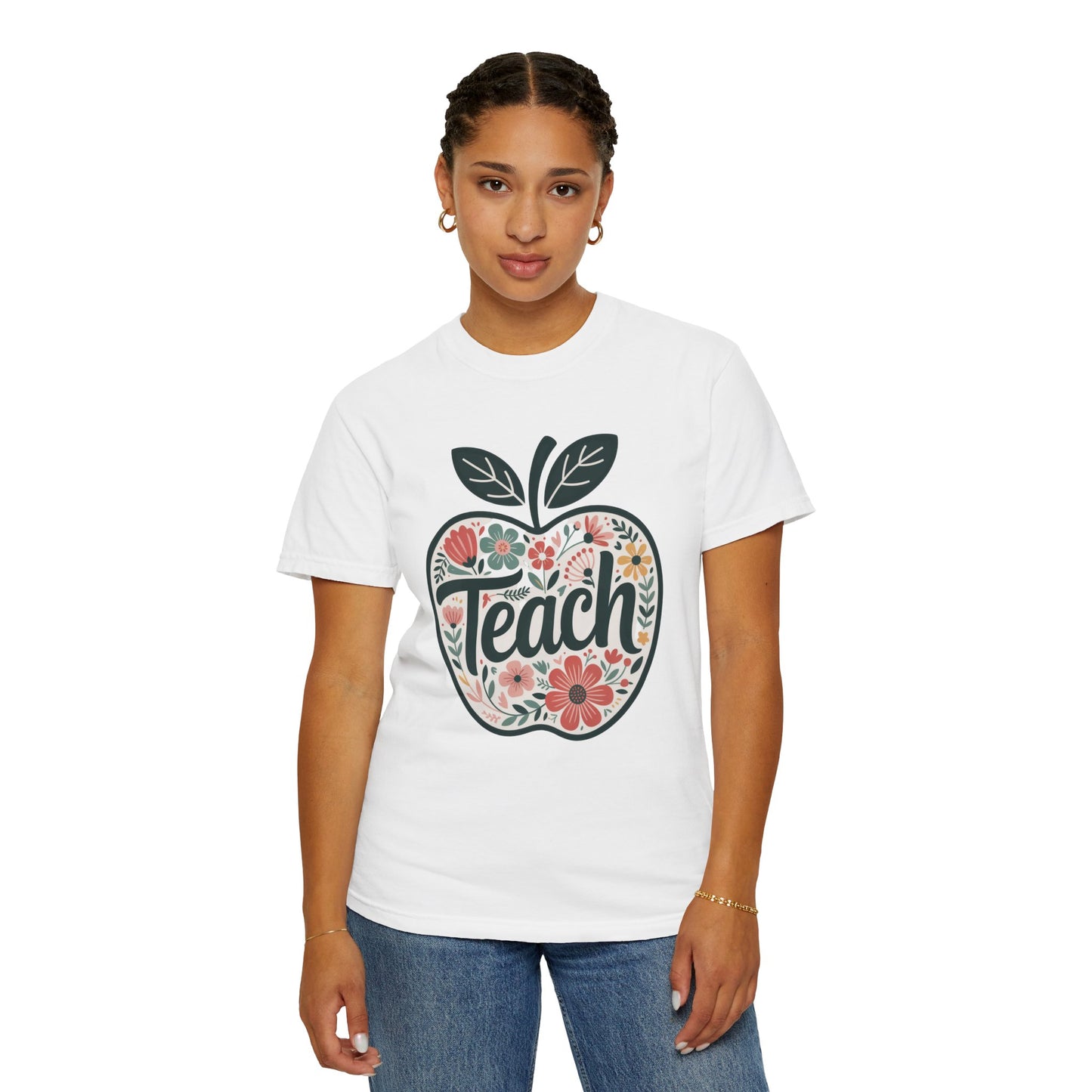 Floral Apple TEACH T-shirt features a large apple with pastel floral design and TEACH text, ideal for educators, embodying FireBrook Essentials' style and positivity.