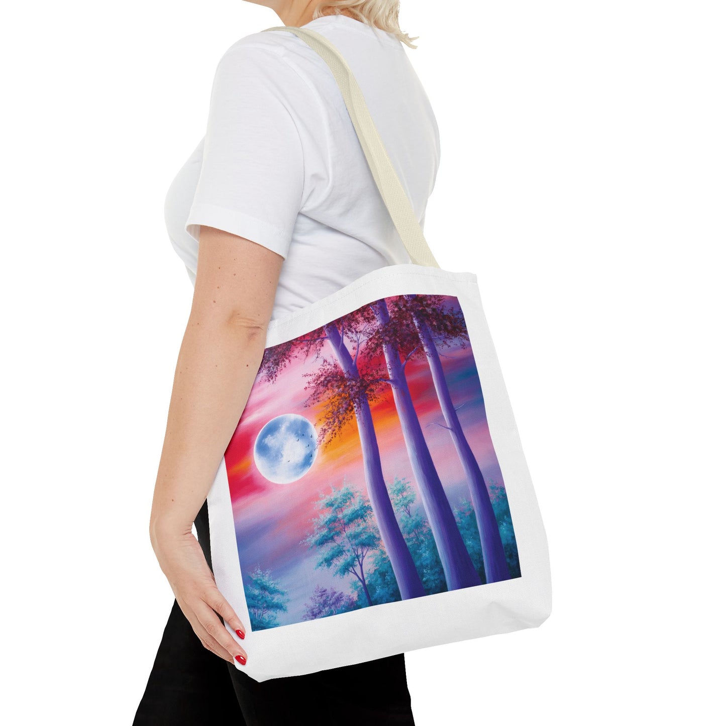 Moonlit Forest Tote Bag featuring a mystical full moon scene with towering trees against a dramatic sunset sky. Designed for art lovers, this durable polyester bag is ideal for everyday use or gifting.