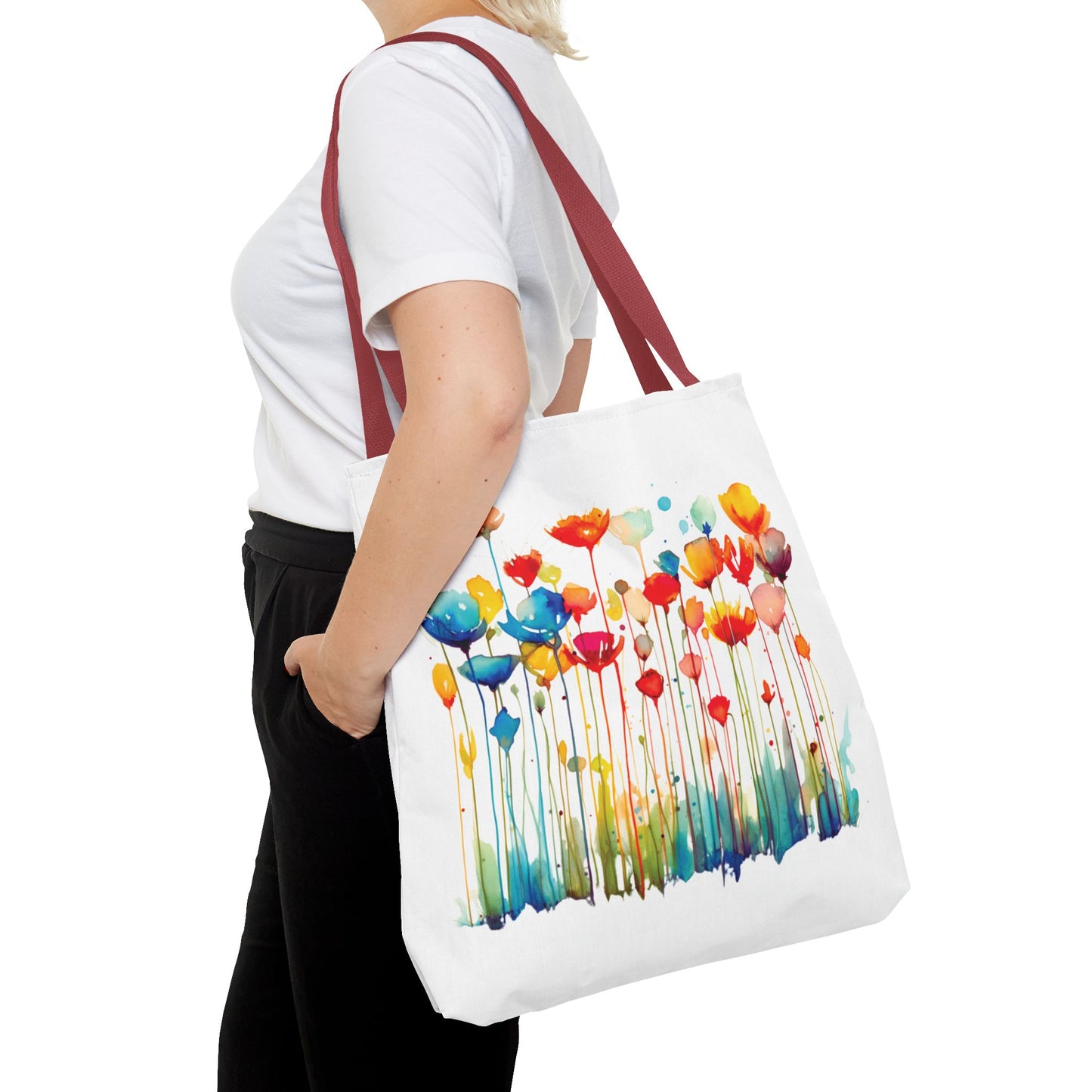 Woman holding a Watercolor Floral Tote Bag, featuring a floral design. Perfect for daily use, combining style and functionality. Available in various sizes from FireBrook Essentials.