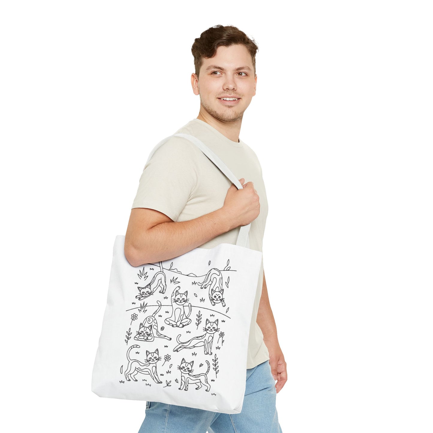 Yoga Cat Tote Bag from FireBrook Designs features whimsical cats in yoga poses, perfect for errands or gifting. Durable polyester with reinforced handles offers practicality and charm for cat lovers and yoga enthusiasts alike.