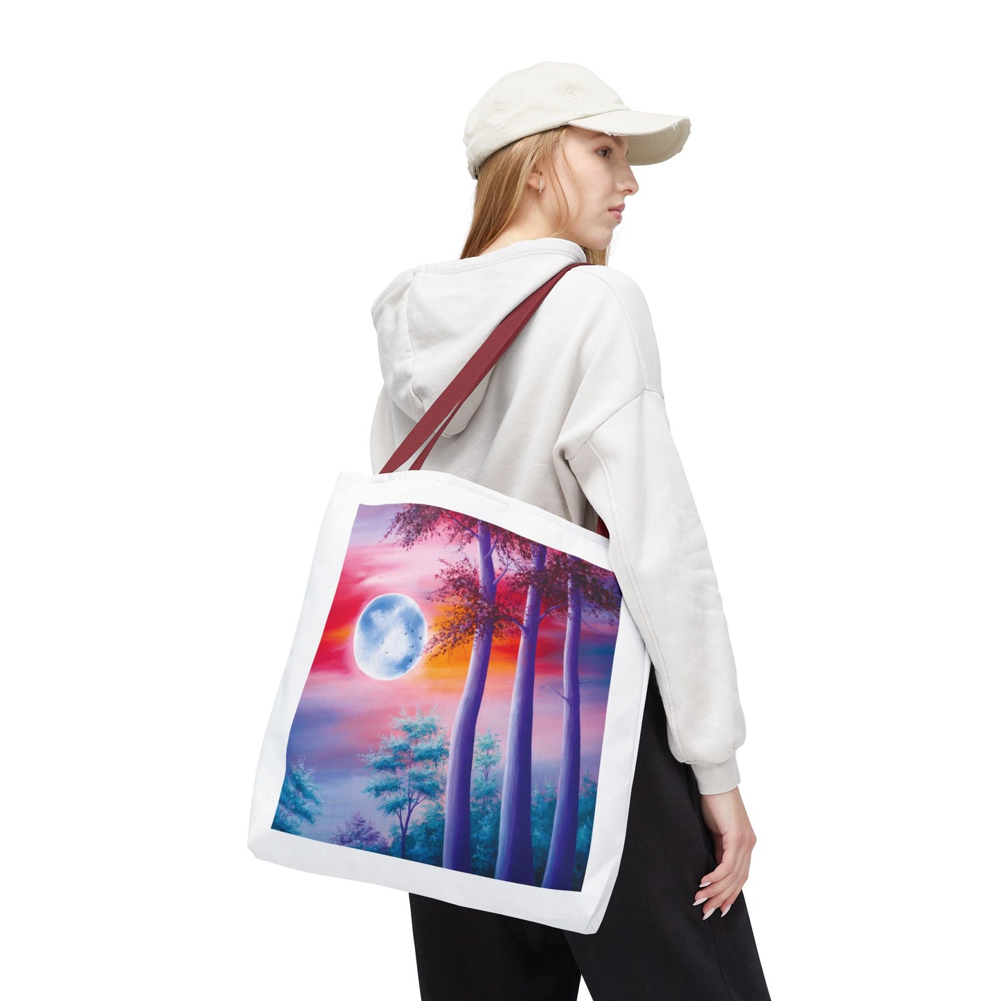 Moonlit Forest Tote Bag featuring a mystical full moon scene with towering trees against a dramatic sunset sky. Durable polyester with reinforced handles, ideal for art lovers and everyday use.