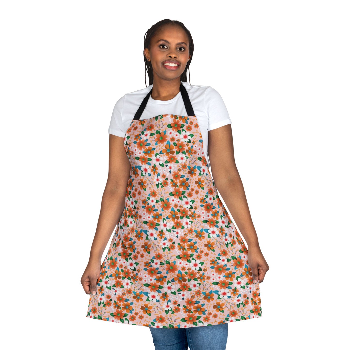 Smiling woman wearing the Floral Apron, featuring a vibrant orange and green floral print, designed for comfort with 100% polyester canvas, perfect for cooking or crafting. From FireBrook Essentials.