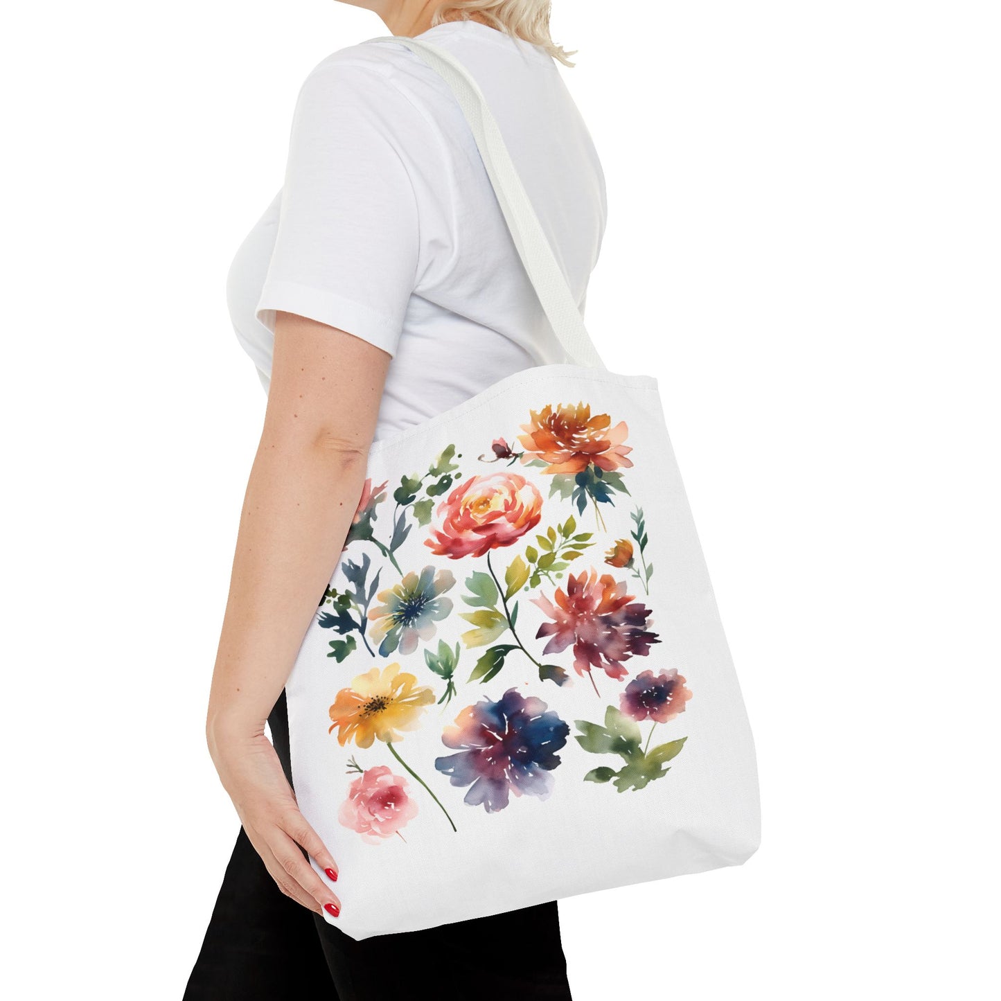 Watercolor Floral Tote Bag: A woman carries a stylish, white tote featuring a vibrant floral design, embodying functionality and nature-inspired charm for everyday use.