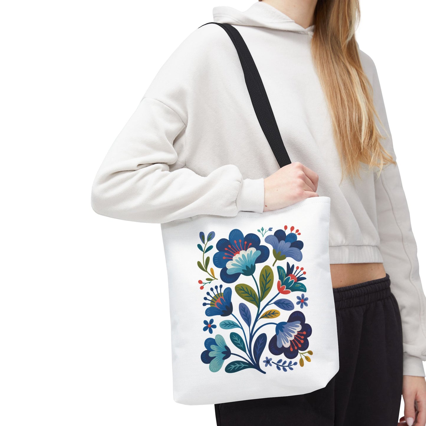 Vintage Folk Art Design Blue Floral Tote Bag featuring a charming, nostalgic blue floral pattern. Ideal for everyday use or special occasions, it embodies unique style with reinforced handles and a durable polyester body.