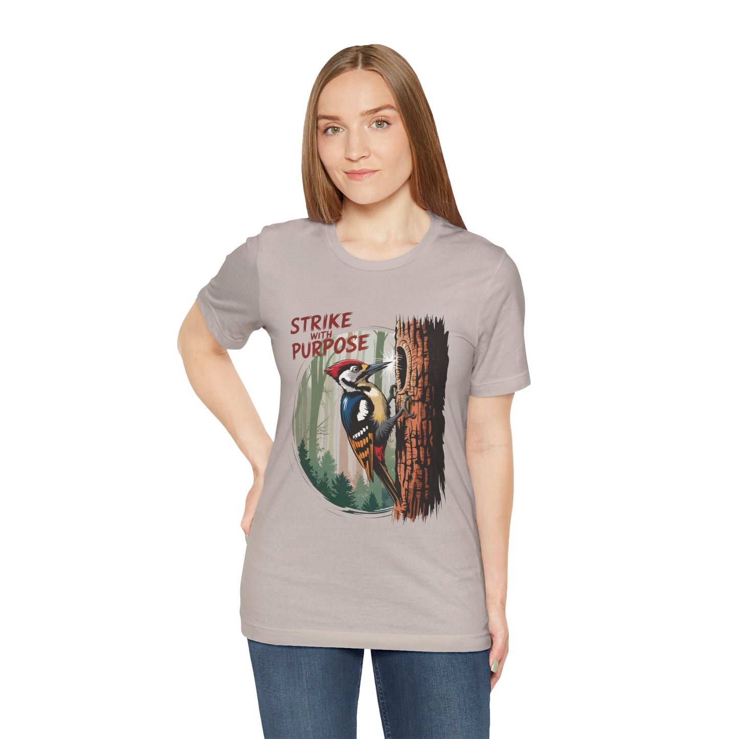Woodpecker: Strike with a Purpose Bella+Canvas Unisex T-Shirt featuring a woman wearing the tee with a bird design, highlighting its casual and meaningful appeal. Perfect for nature enthusiasts seeking inspiration.
