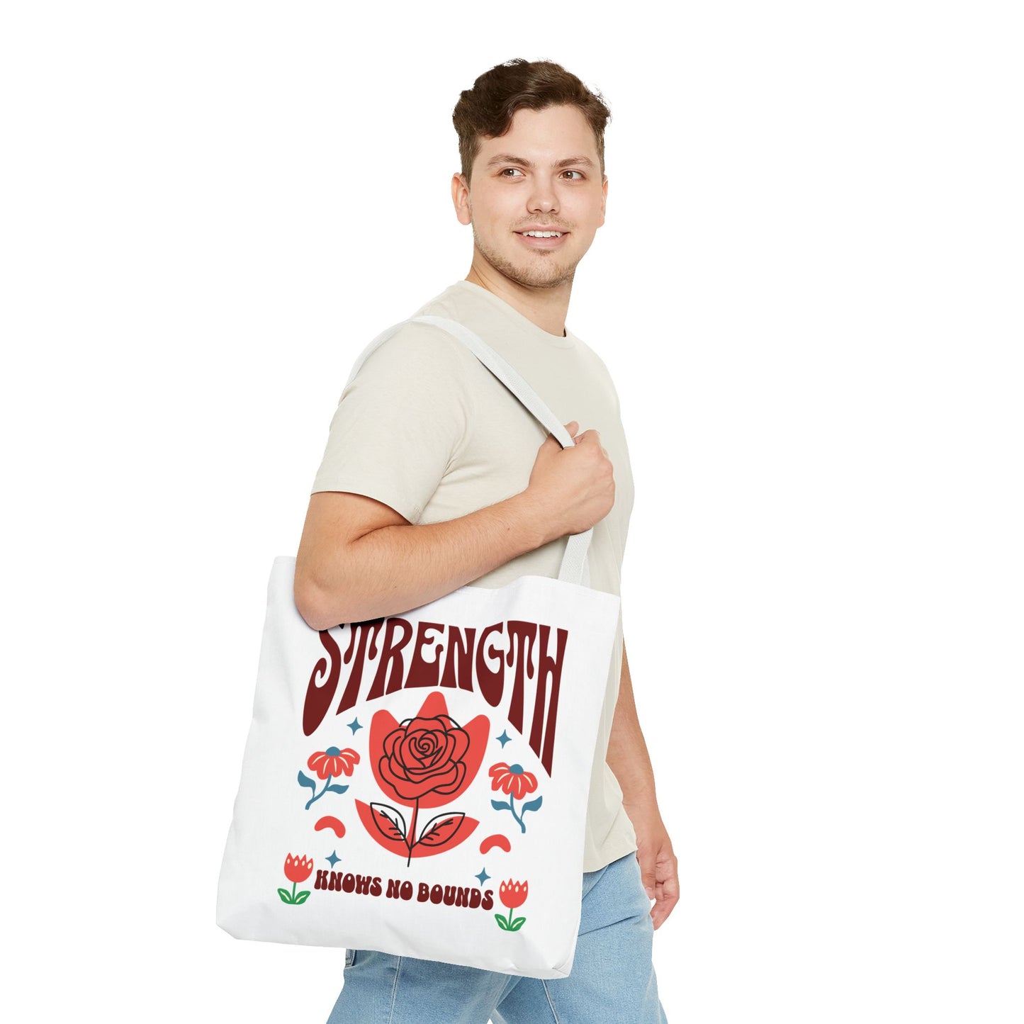 Man holding a Strength Knows No Bounds Tote Bag with a red rose design, exemplifying durability and style from FireBrook Essentials.