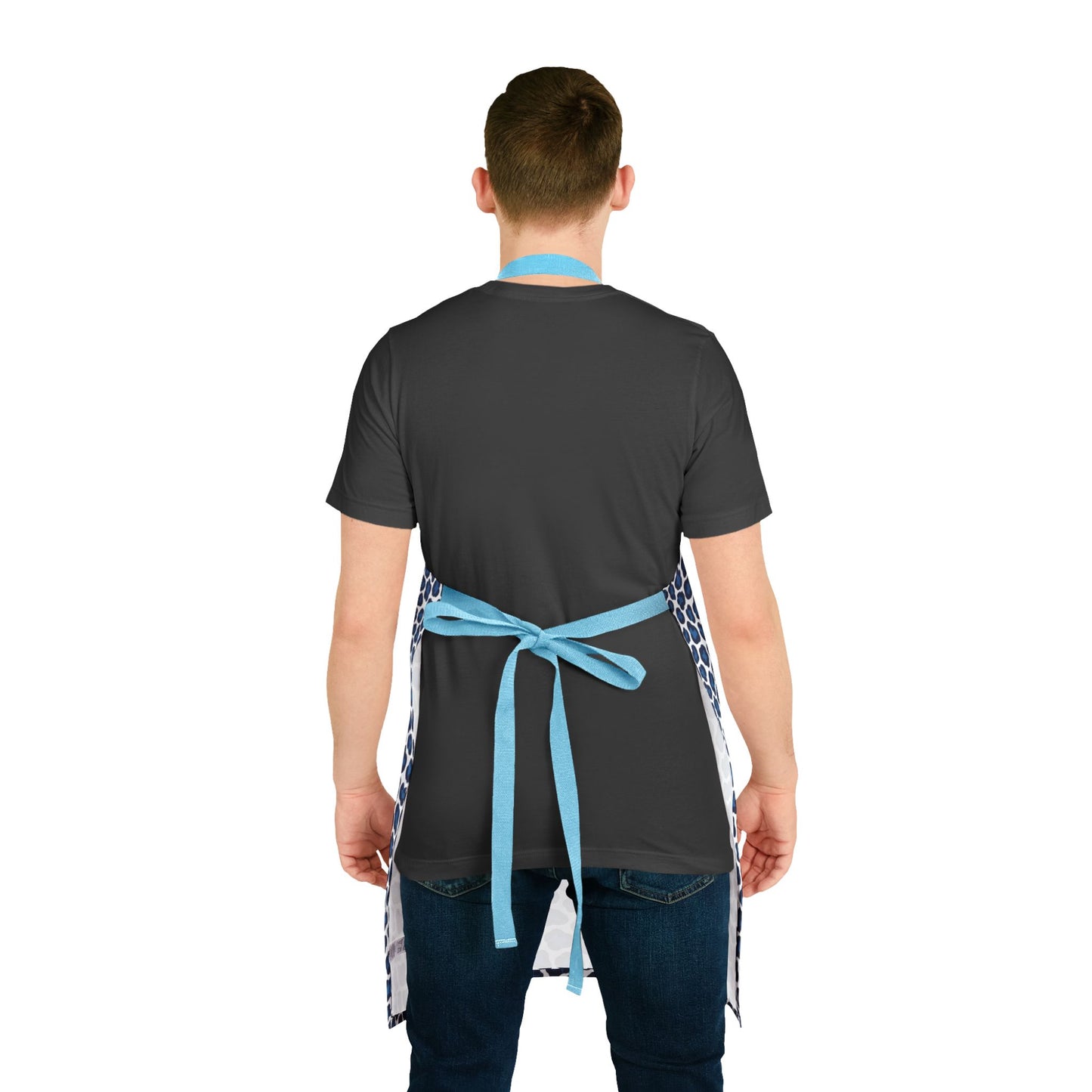 Apron, Cheetah Print: A close-up of a hand tying a blue ribbon around a stylish apron with a bold cheetah pattern, showcasing its soft texture and comfortable tie-back closure.