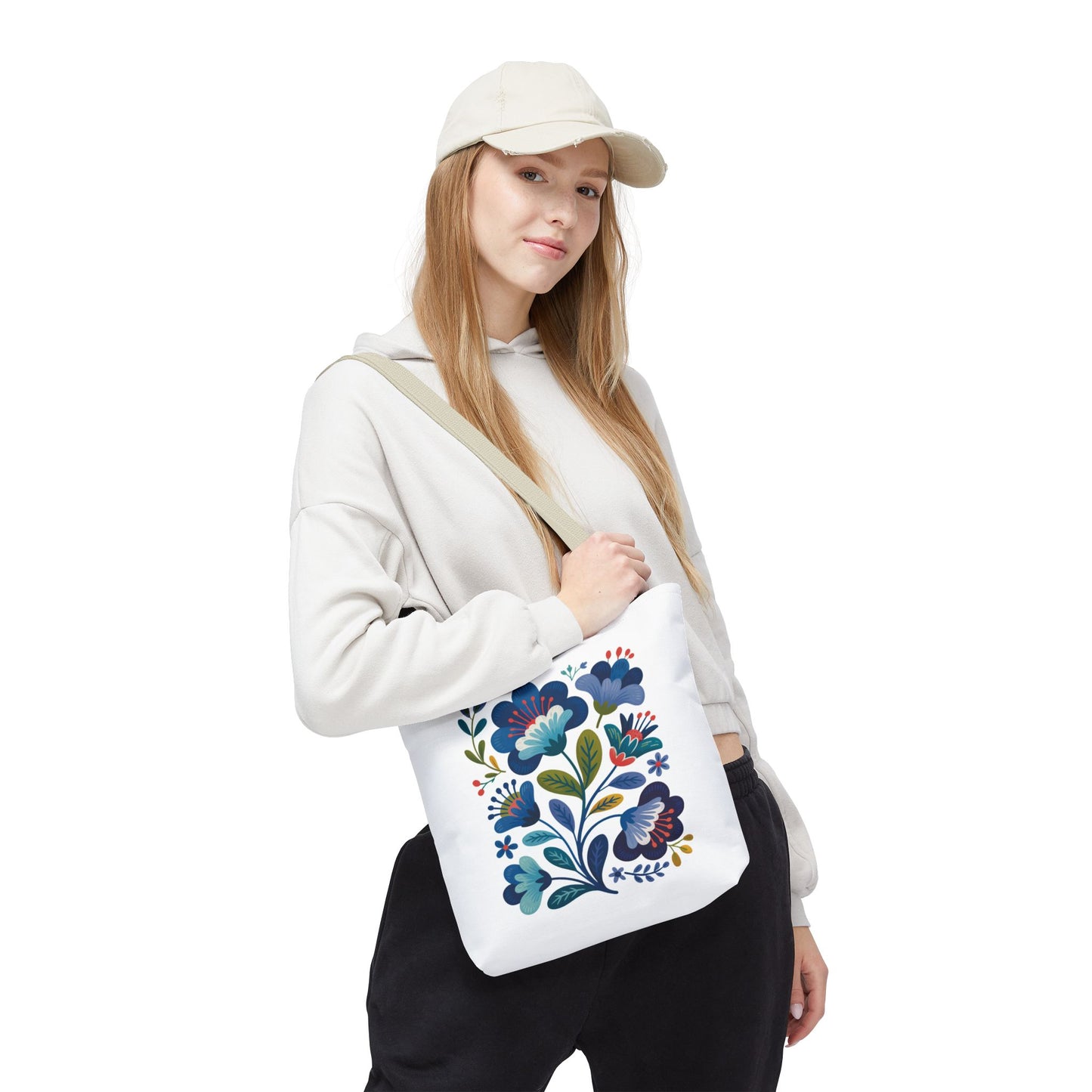 Vintage Folk Art Design Blue Floral Tote Bag featuring a charming, nostalgic floral pattern. Perfect for everyday use or special occasions, this tote offers durability with a 100% polyester body and reinforced handles.