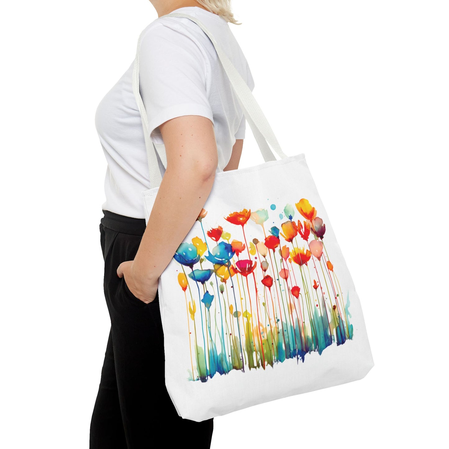 Woman holding a Watercolor Floral Tote Bag with a floral design, showcasing its versatility as a stylish and functional accessory for everyday use.