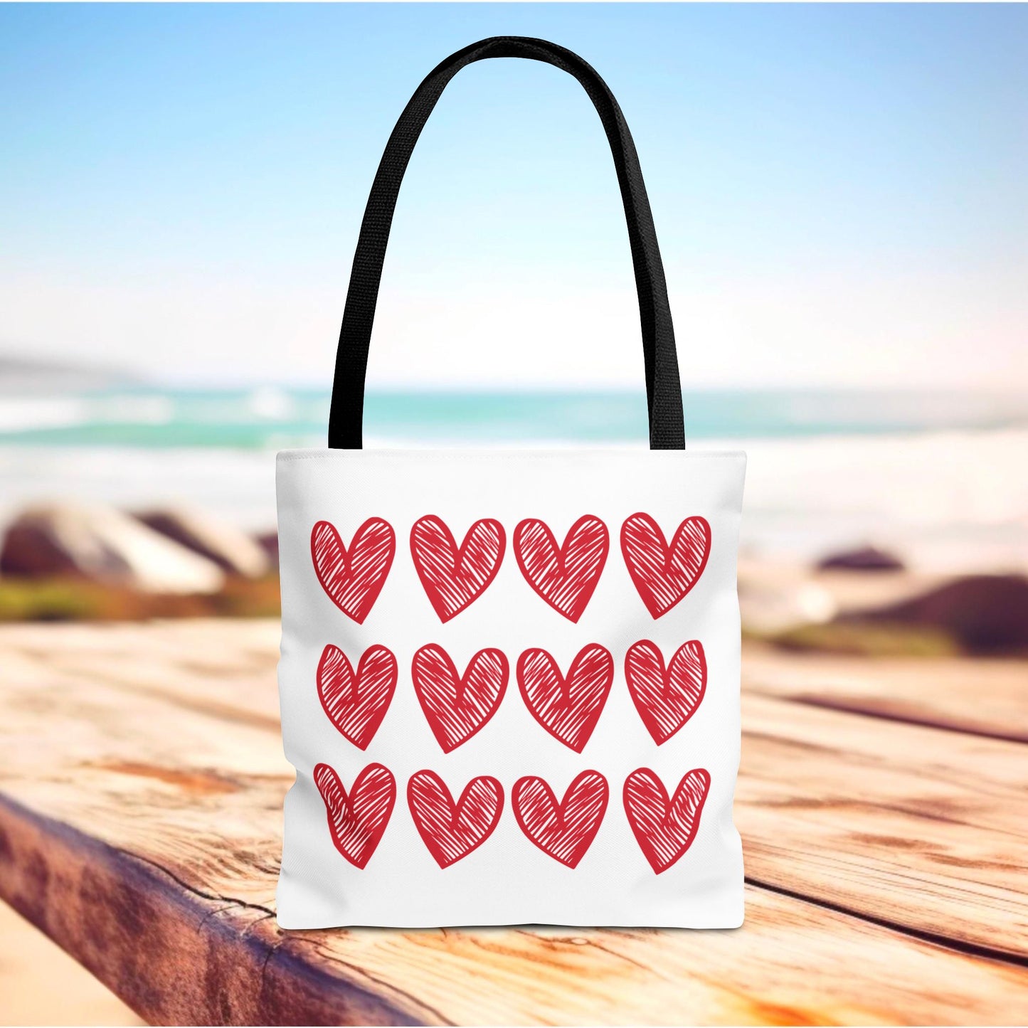 Hearts Tote Bag adorned with playful red hearts, exemplifying FireBrook Essentials' joyful and stylish aesthetic. Perfect for adding a cheerful, loving touch to everyday wear, with durable polyester and spacious design.