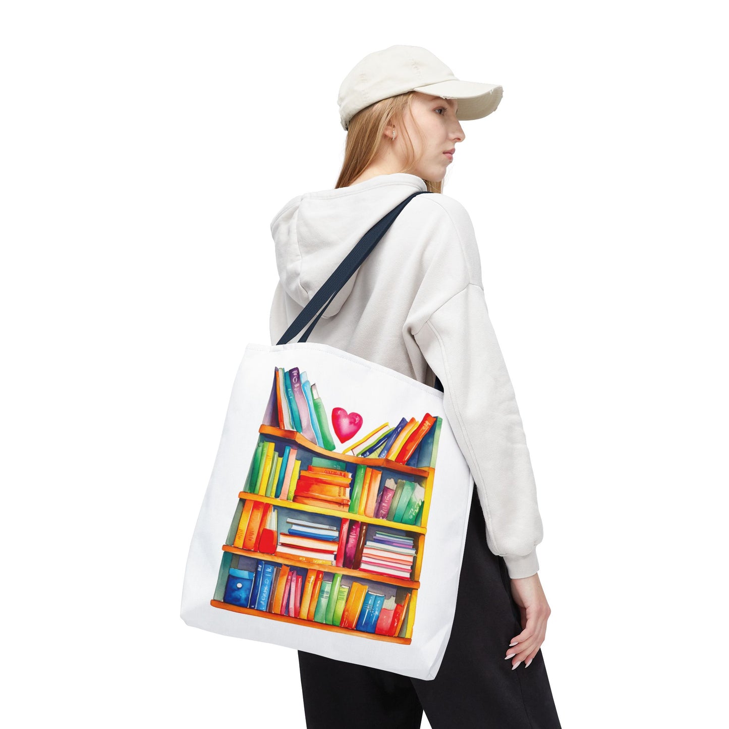 Woman in white hat and sweatshirt carrying the Books Tote Bag - 100% Spun Polyester, featuring a bookshelf design, ideal for book lovers and daily use.