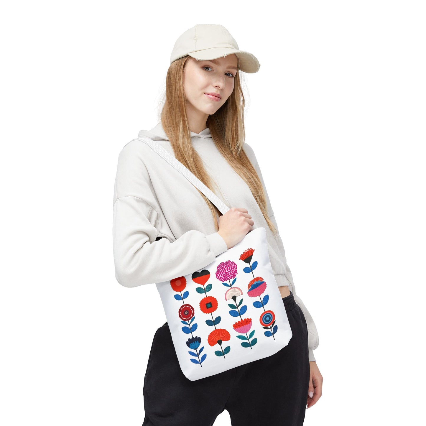 Woman holding a Floral Pattern Tote Bag with a pink flower and blue leaves, showcasing style and practicality for everyday use.