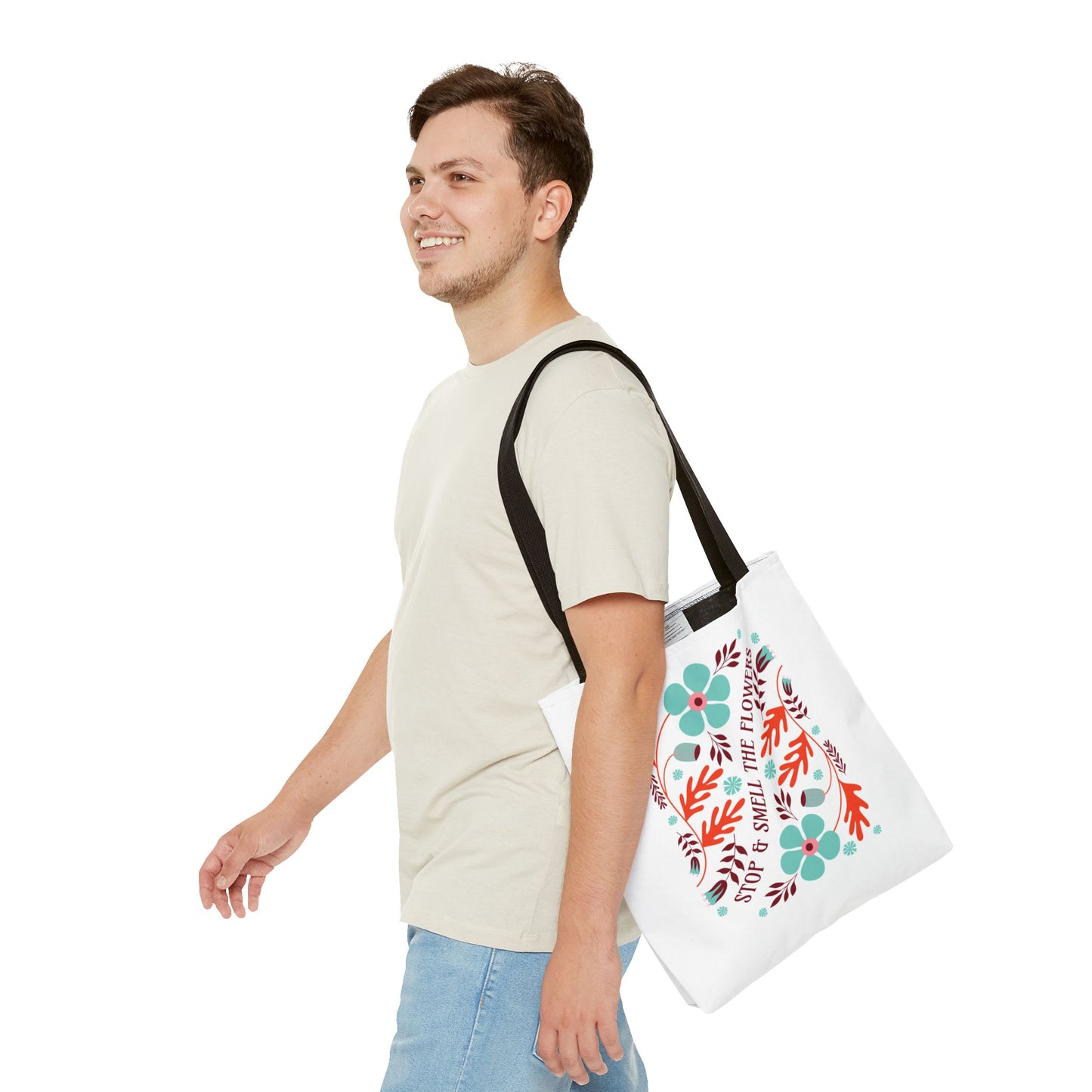 Stop and Smell The Flowers Tote Bag carried by a smiling man; features floral design, durable polyester, and reinforced handles, ideal for everyday essentials.