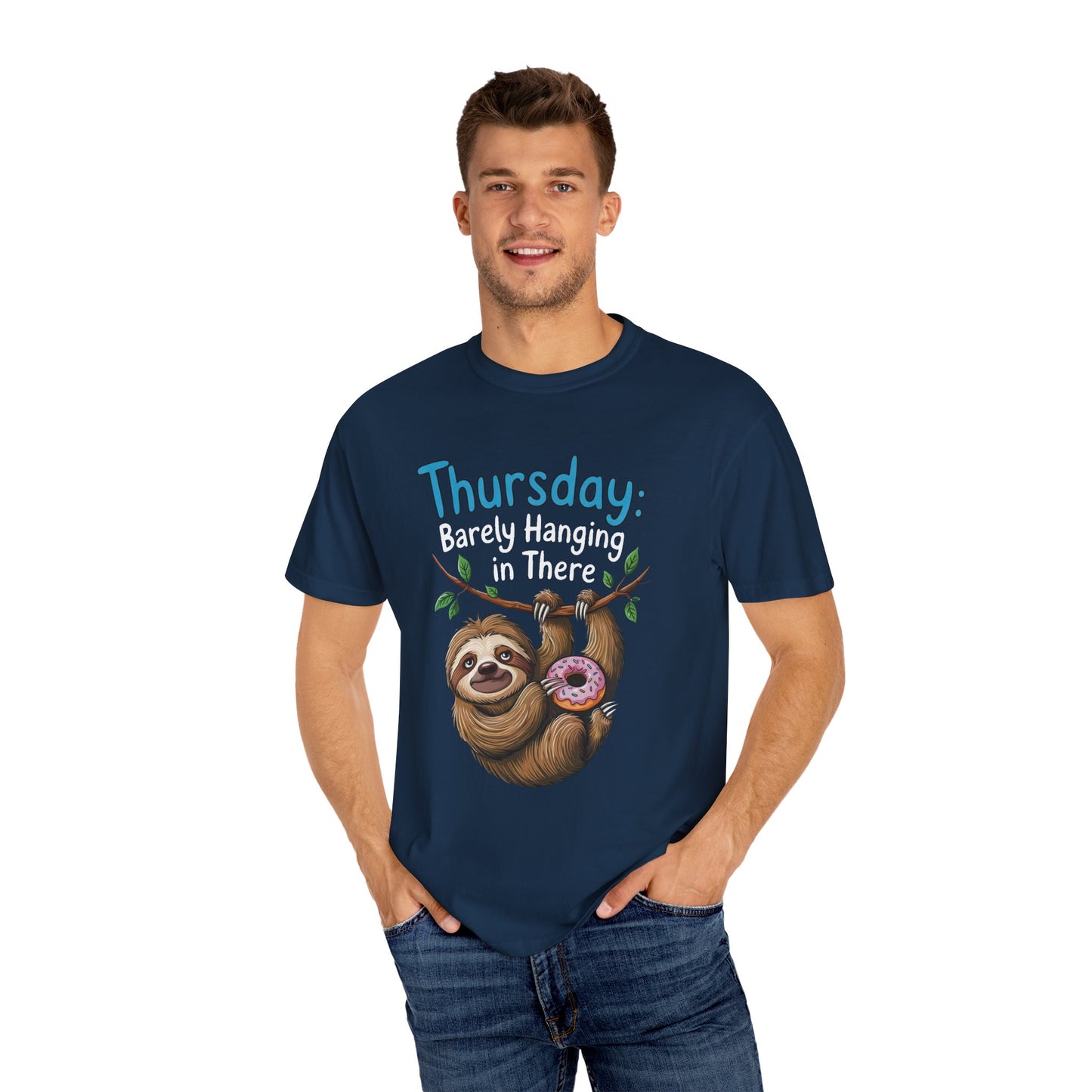 Thursday: Barely Hanging In There Sloth Graphic Comfort Colors Unisex T-Shirt featuring a man smiling, wearing the tee with a sloth holding a donut illustration, epitomizing casual comfort and playful design.