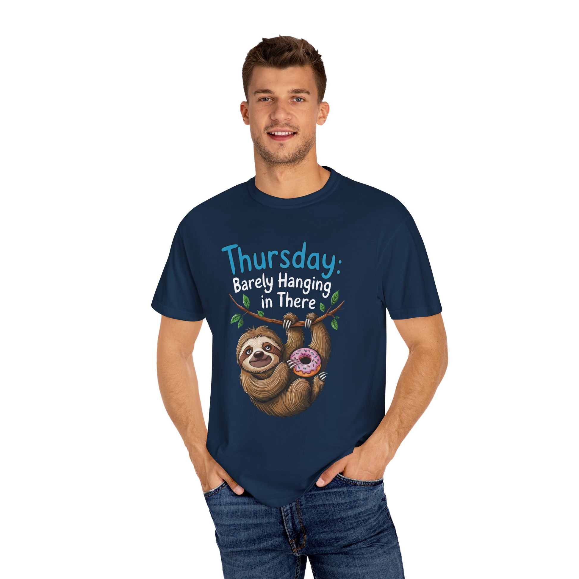 Thursday: Barely Hanging In There Sloth Graphic Comfort Colors Unisex T-Shirt featuring a man smiling, wearing the tee with a sloth holding a donut illustration, epitomizing casual comfort and playful design.