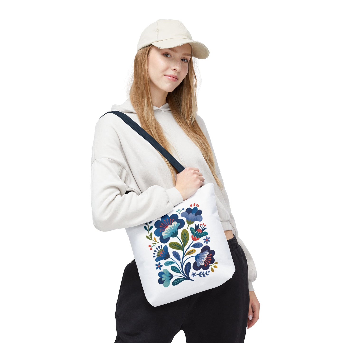 Vintage Folk Art Design Blue Floral Tote Bag, showcasing intricate blue floral patterns, combines charm and durability with its polyester build and reinforced handles, perfect for both everyday use and special occasions.