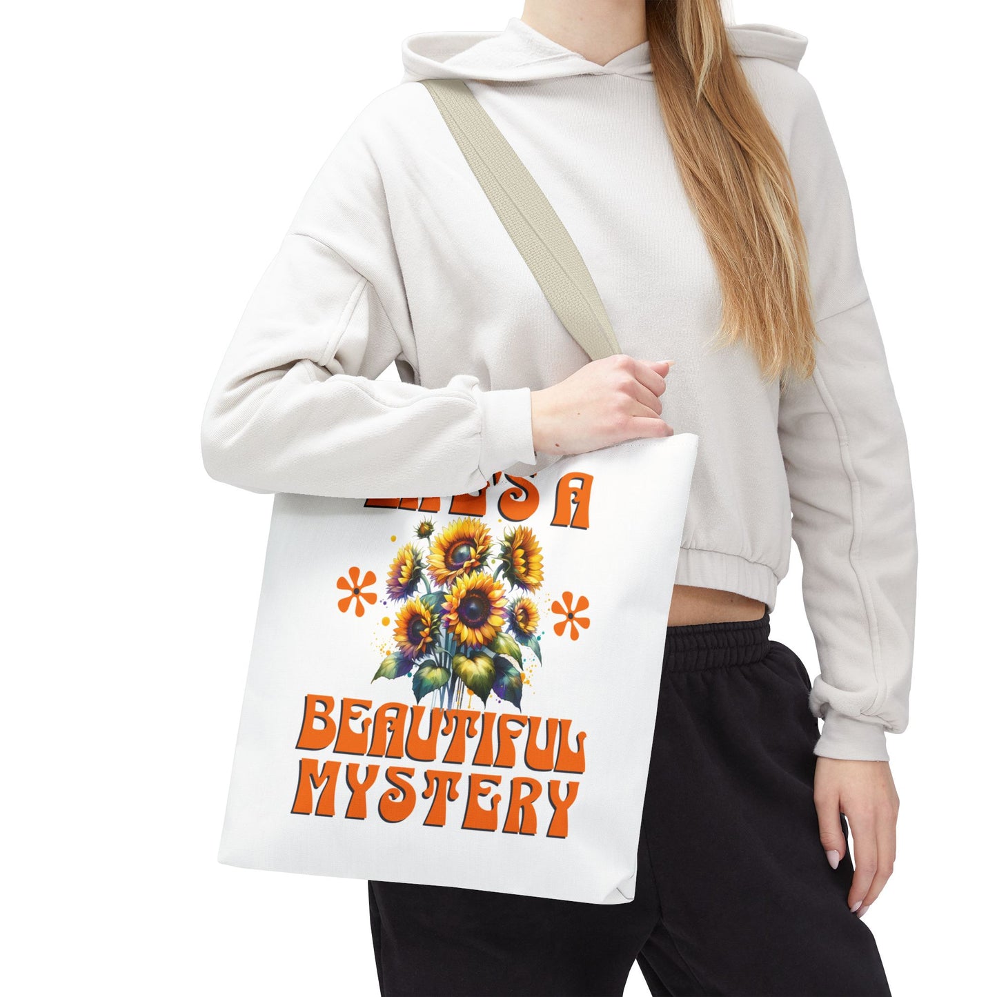 Life's A Beautiful Mystery Tote Bag held by a woman, featuring sunflower design, captures a sense of wonder. Ideal for everyday adventures and celebrating life's surprises.