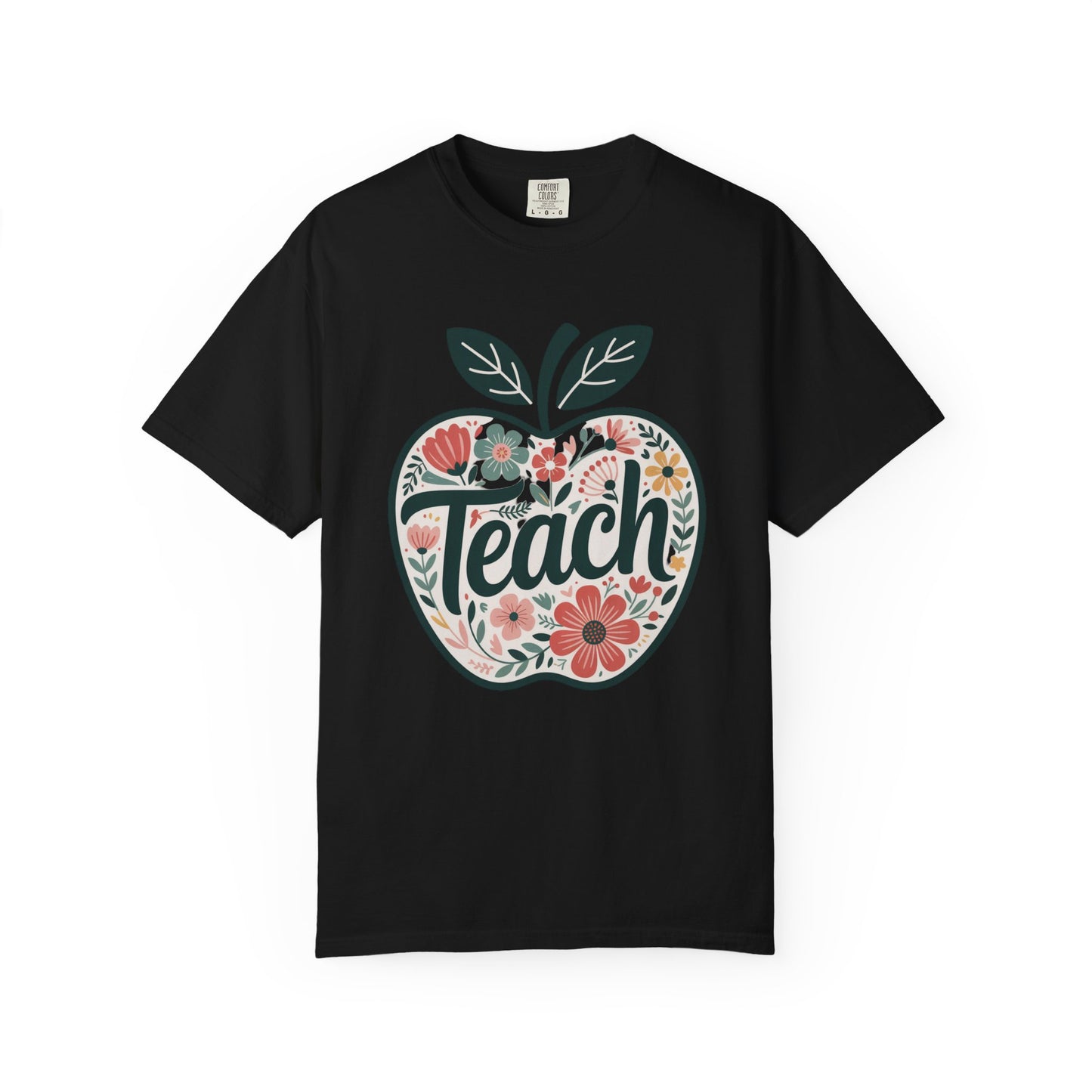 Floral Apple TEACH T-shirt displays a large apple with pastel florals, overlaid by TEACH in textured script, embodying a cheerful, artistic style perfect for educators.