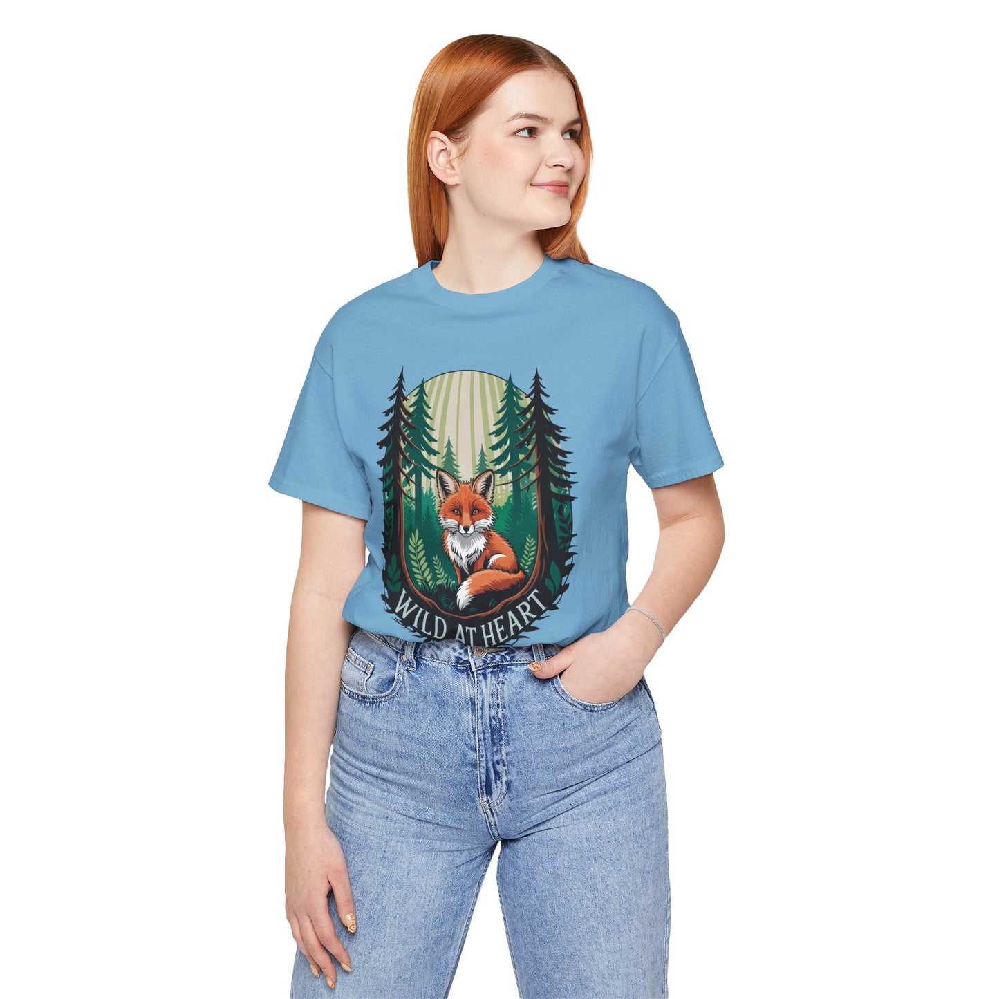 Wild at Heart Fox Illustration Bella+Canvas Unisex T-Shirt featuring a whimsical fox and trees design, worn by a woman in casual jeans, epitomizing FireBrook Essentials' blend of comfort and style.