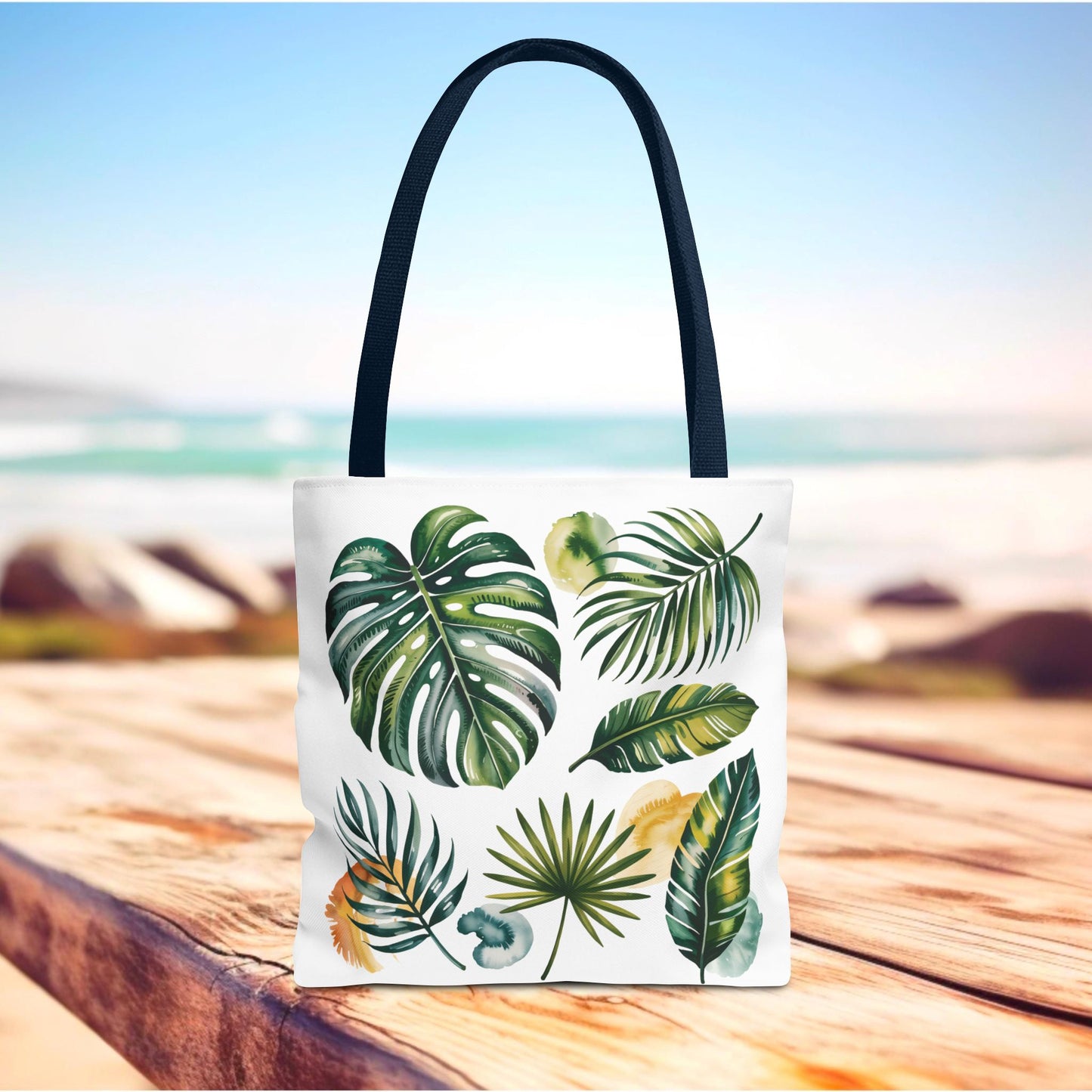 Tropical Leaves Tote Bag, featuring a vibrant green leaf design on a white background, offers a spacious, durable carry option with reinforced black-stitched handles, ideal for beach outings and everyday use.