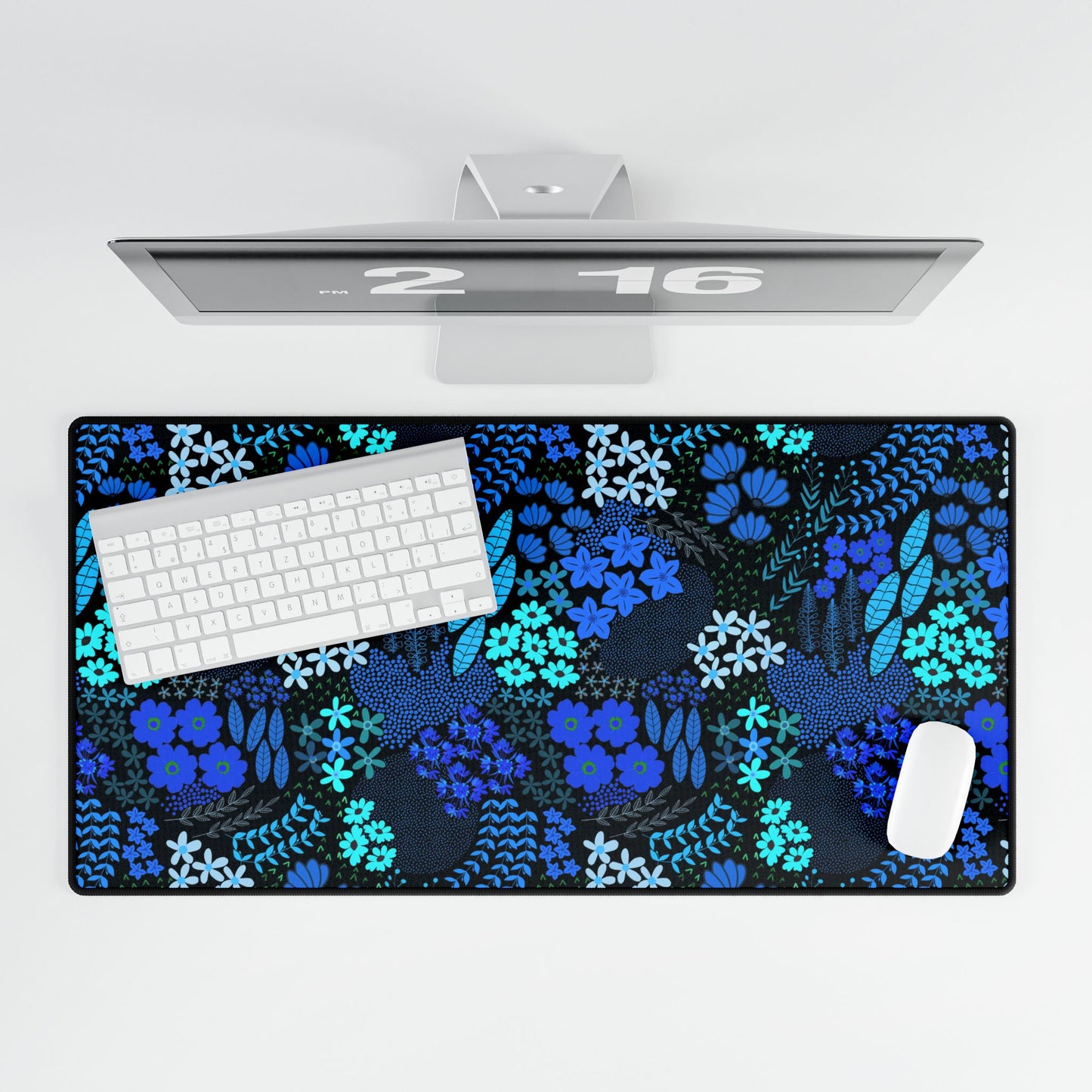 Blue Floral Desk Mat with elegant blue-and-turquoise botanical pattern. Showcased with white wireless keyboard and mouse, it adds sophistication and style to your workspace, embodying FireBrook Designs’ uplifting essence.