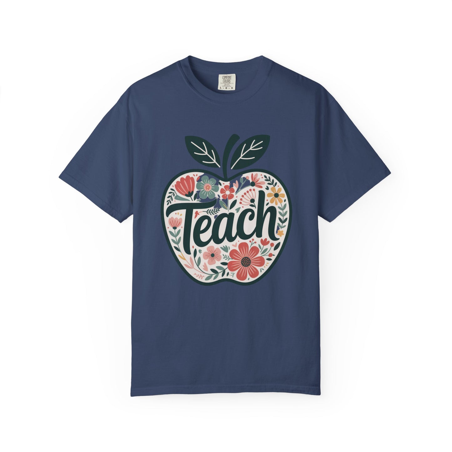 Floral Apple TEACH T-shirt with a large apple design filled with pastel floral illustrations and TEACH in textured script, embodying FireBrook Essentials' joyful and stylish apparel ethos.