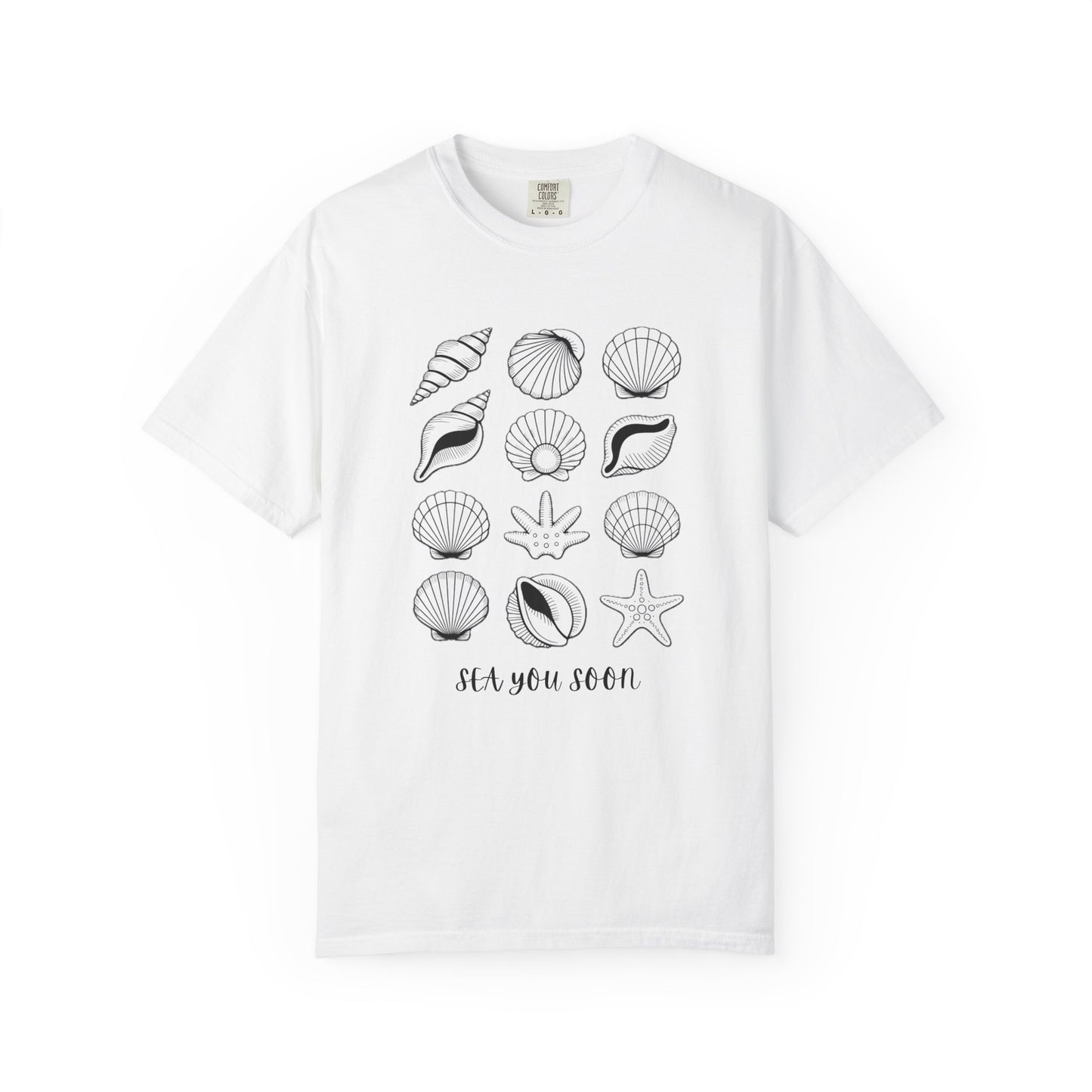 Seashells and Sea You Soon T-Shirt featuring a seashell design and uplifting text, embodies a relaxed beach vibe perfect for ocean lovers, crafted with durable, ethically sourced US cotton for comfort.