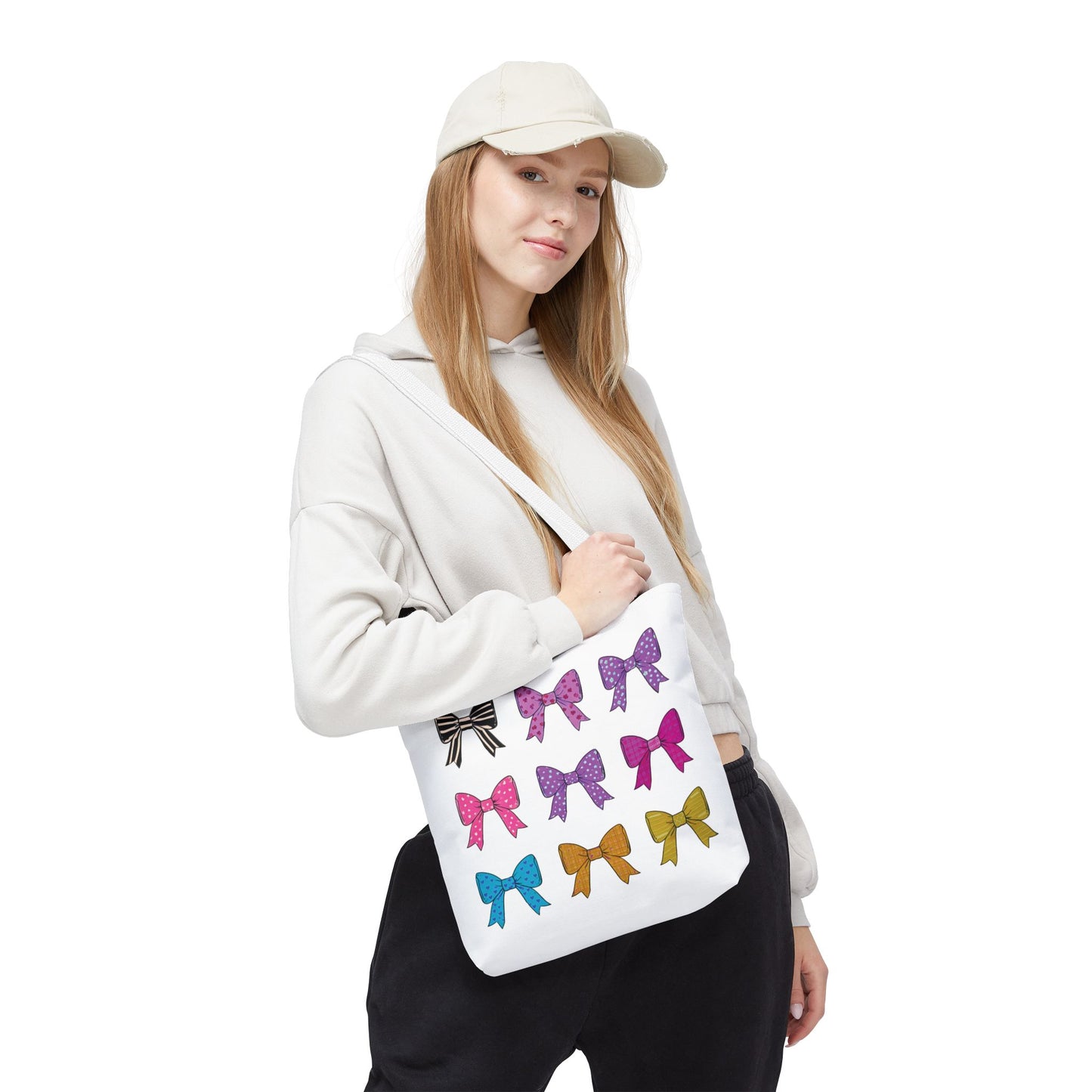 Woman holds the Bows Ribbons Tote Bag, featuring decorative bows, exemplifying stylish practicality from FireBrook Essentials.