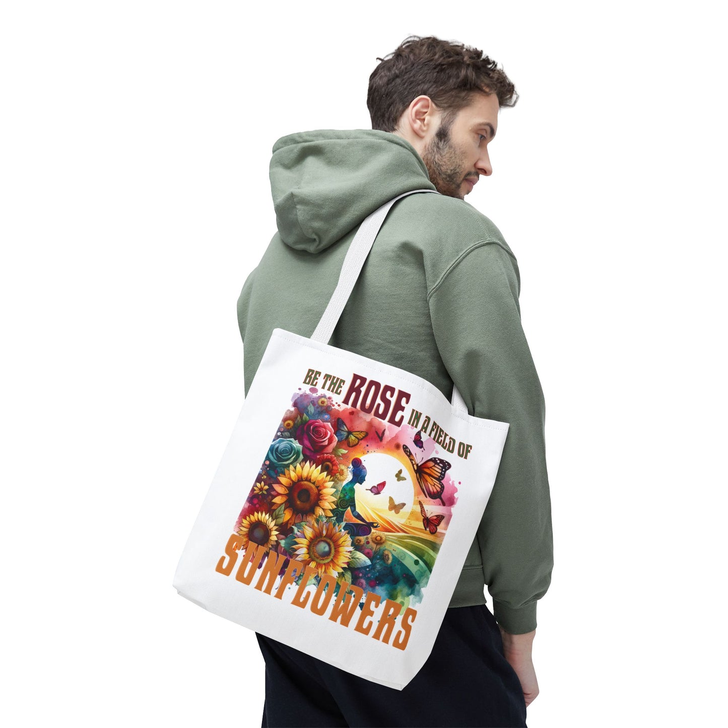Be the Rose in a Field of Sunflowers Tote Bag, featuring floral and butterfly design, carried by person wearing green jacket, showcasing nature-inspired, motivational style.