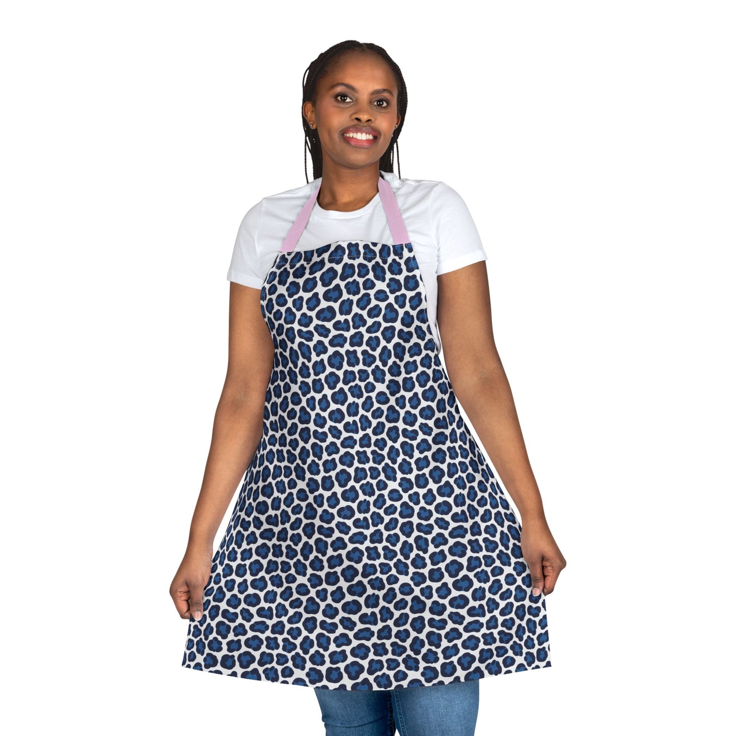 Apron, Cheetah Print: A close-up of a woman smiling while wearing a stylish apron with a bold blue cheetah print, showcasing its soft polyester canvas and tie-back closure for a comfortable fit.