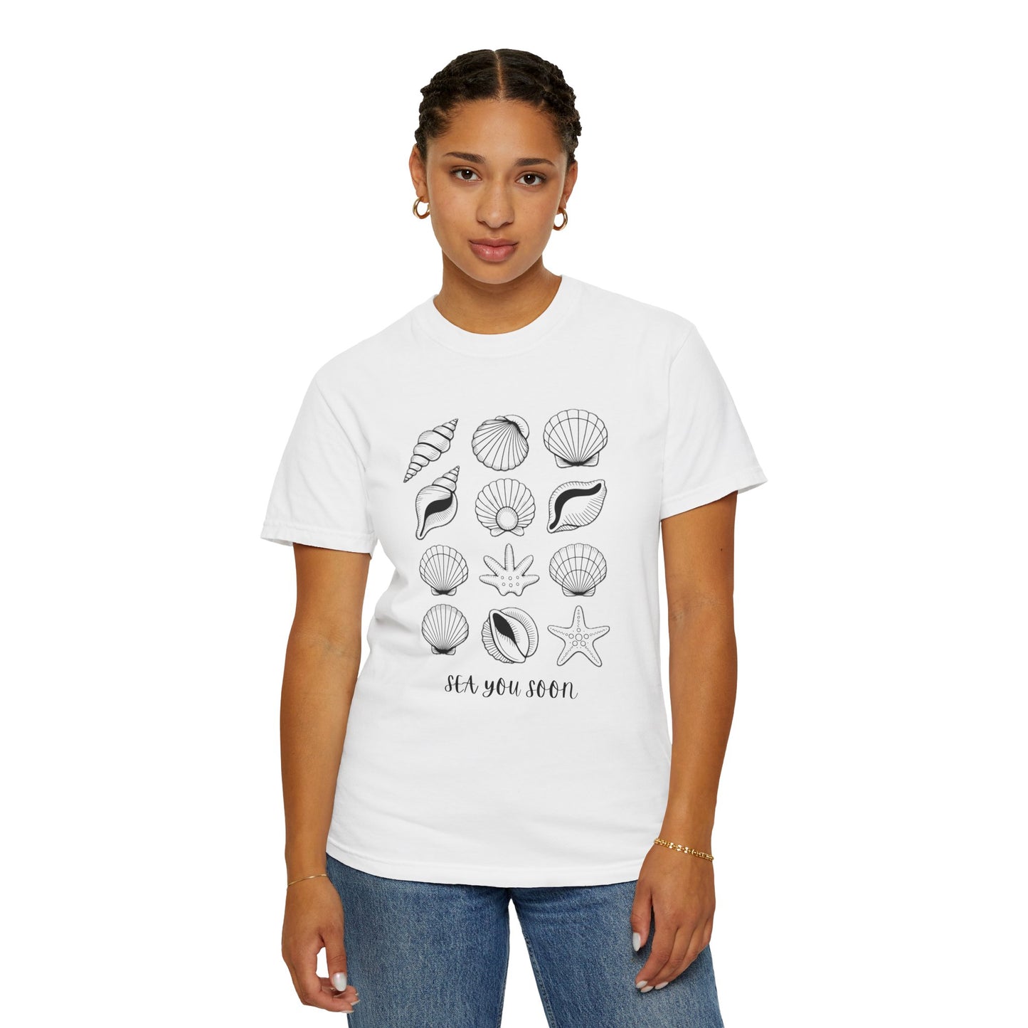 Seashells and Sea You Soon T-Shirt with seashell design and text, showcasing a relaxed beach vibe. Features a crew neckline and relaxed fit, perfect for seaside vacations and casual wear.