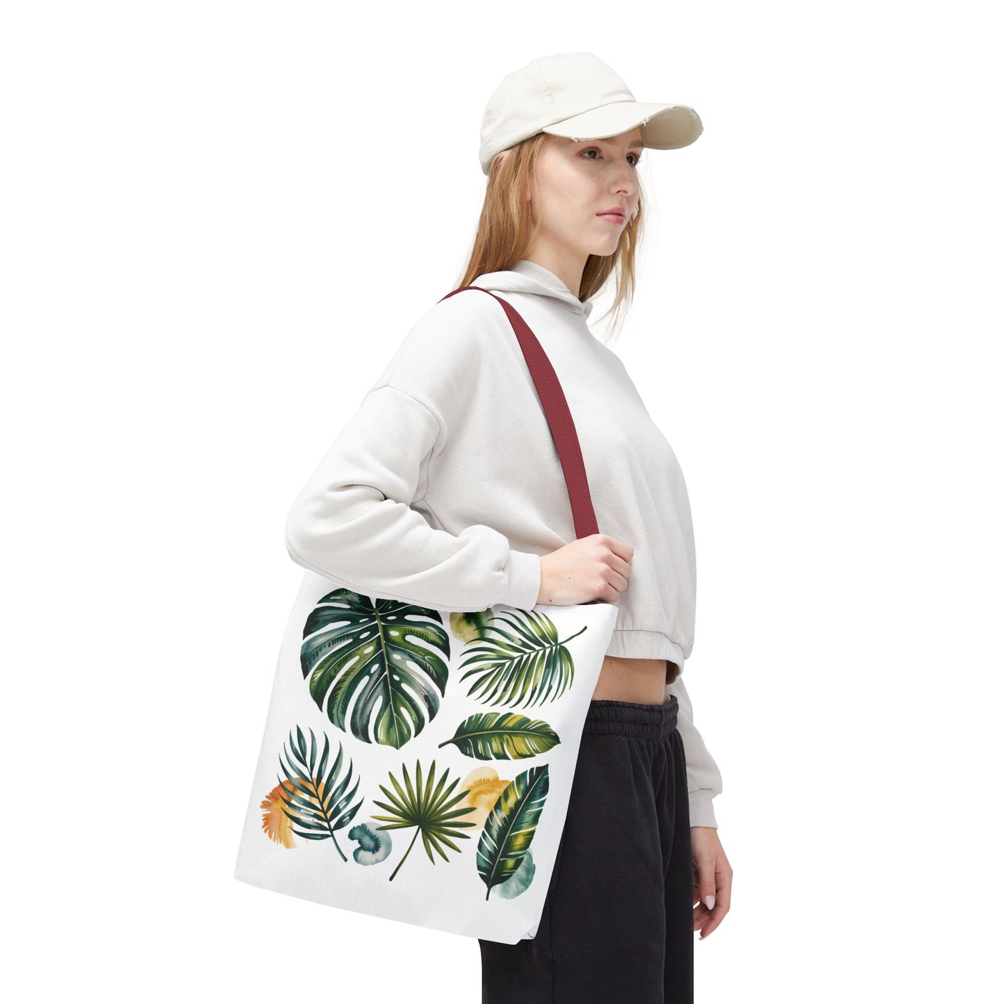 Close-up of a hand holding the Tropical Leaves Tote Bag, showcasing its spacious design and reinforced handles, embodying FireBrook Essentials' commitment to stylish, durable, and uplifting fashion accessories for everyday use.