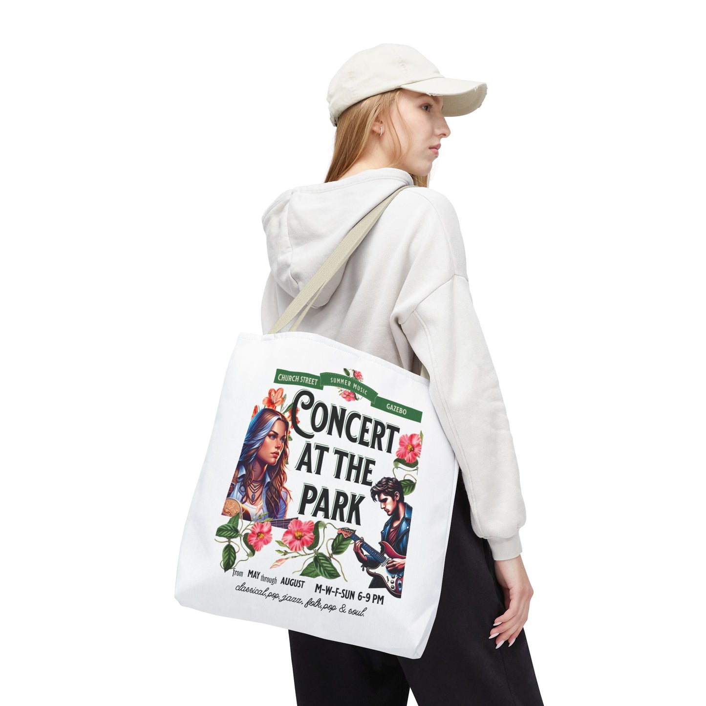 Concert At the Park Tote Bag featuring a lively concert design, worn by a woman with a white hat and sweatshirt. Ideal for music lovers and outdoor activities.