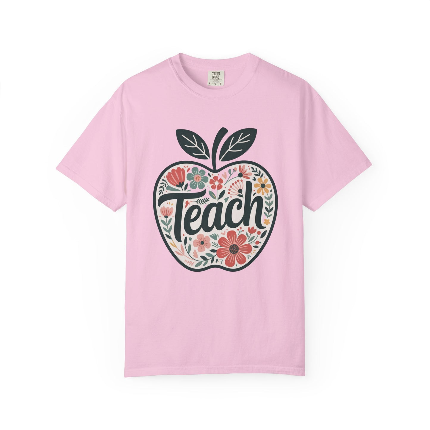 Floral Apple TEACH T-shirt: Unisex garment-dyed tee with a large apple filled with pastel floral art, overlaid with TEACH in textured script, embodying a whimsical, artistic vibe. Ideal for educators.