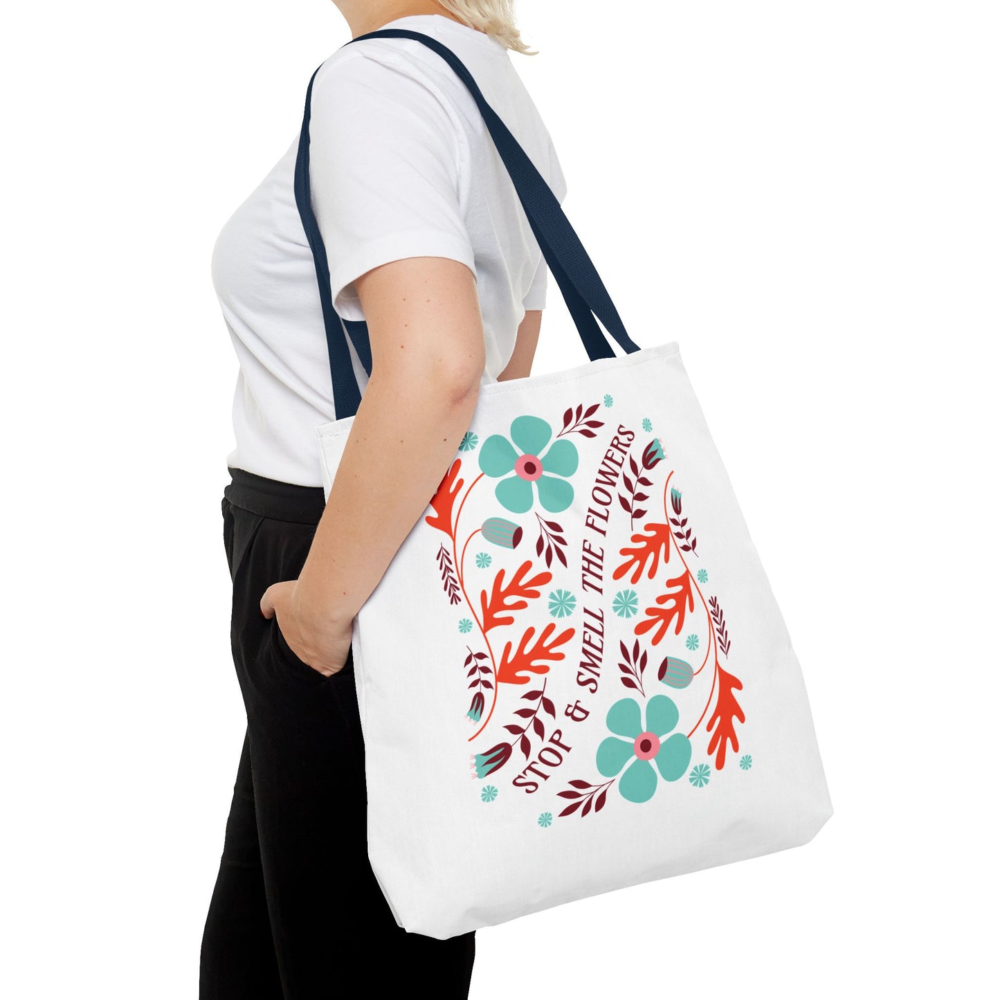 Stop and Smell The Flowers Tote Bag held by a woman, featuring floral patterns, perfect for carrying essentials with positive vibes.