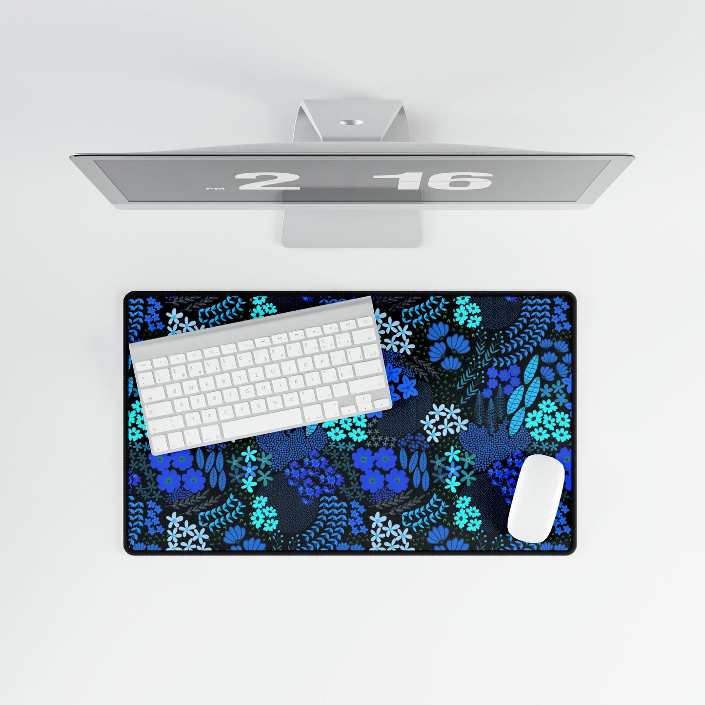 Blue Floral Desk Mat with elegant blue and teal floral patterns, topped with a white wireless keyboard and mouse, enhances any workspace with style and functionality, showcasing FireBrook Designs' uplifting aesthetic.