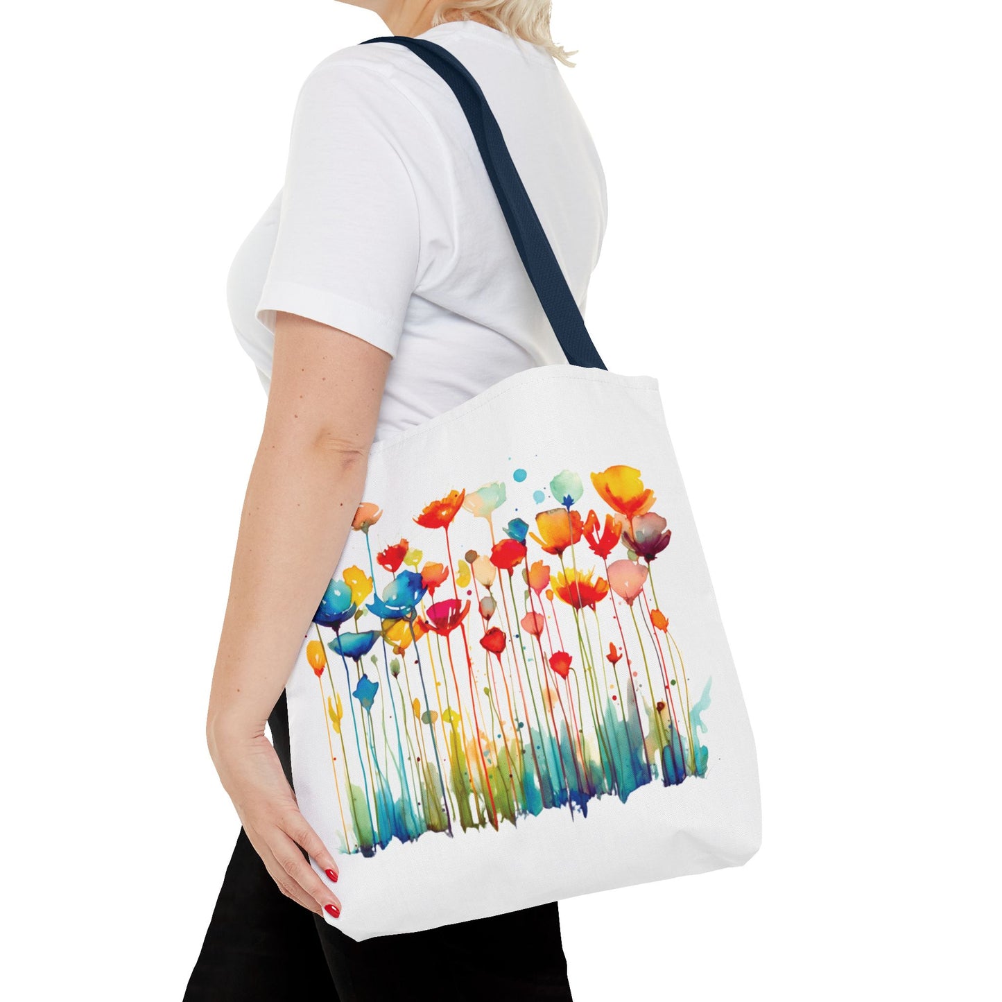Watercolor Floral Tote Bag: A woman holds a stylish white tote featuring vibrant floral designs, perfect for daily errands or outdoor adventures.