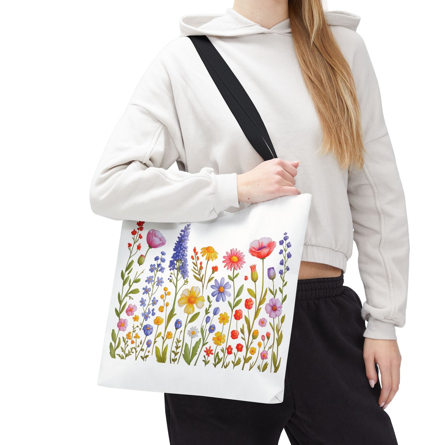 Wildflowers Tote Bag features a vibrant wildflower design, embodying a natural, free-spirited essence. Durable polyester build, reinforced handles, and spacious boxed corners make it ideal for everyday adventures.