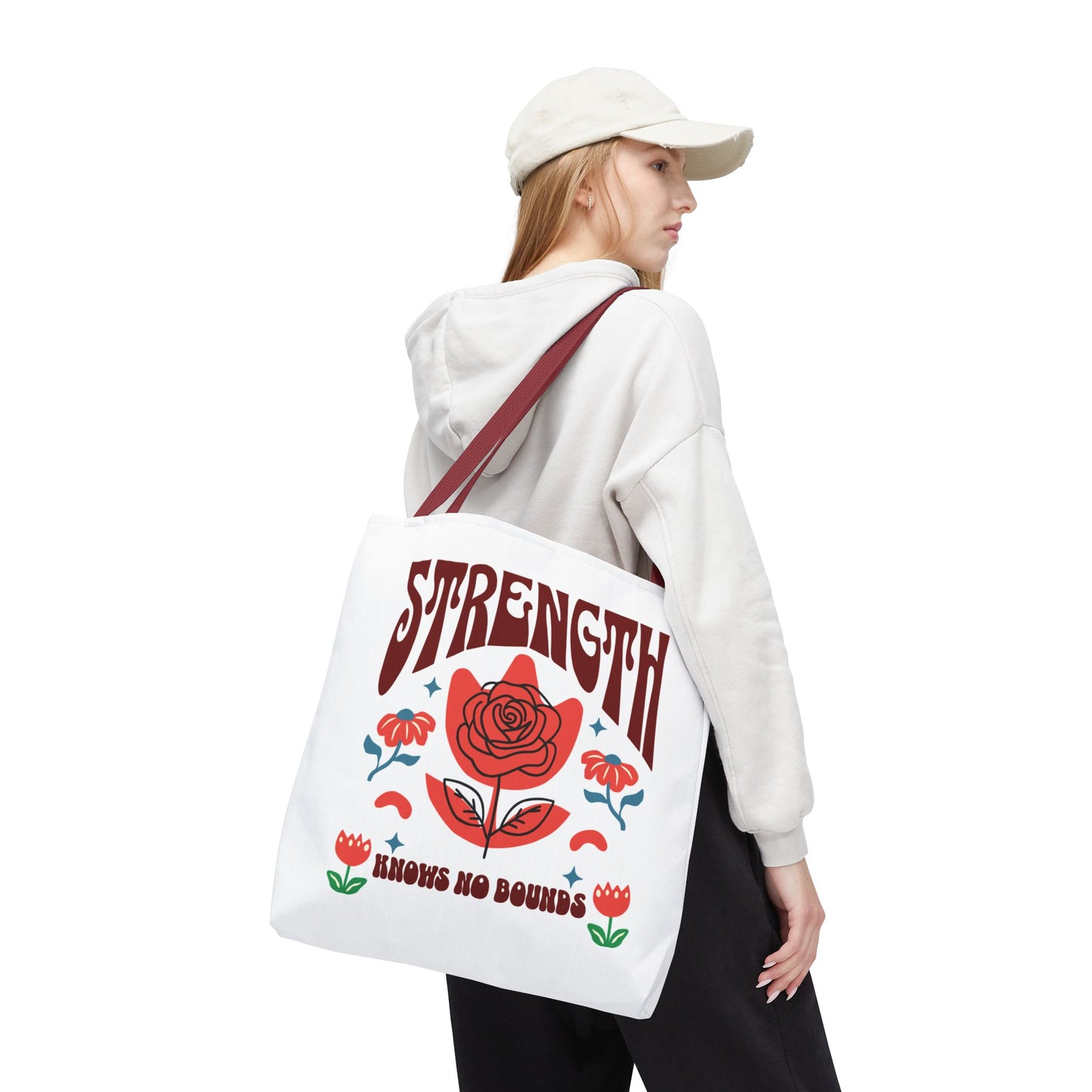 Strength Knows No Bounds Tote Bag worn by a woman, showcasing its durability and style, perfect for daily use and motivational gifting.