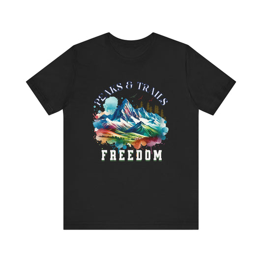 Peaks and Trails Equal Freedom Bella+Canvas Unisex T-Shirt featuring a mountain graphic with colorful paint splashes and white text, ideal for outdoor enthusiasts seeking comfort and style.