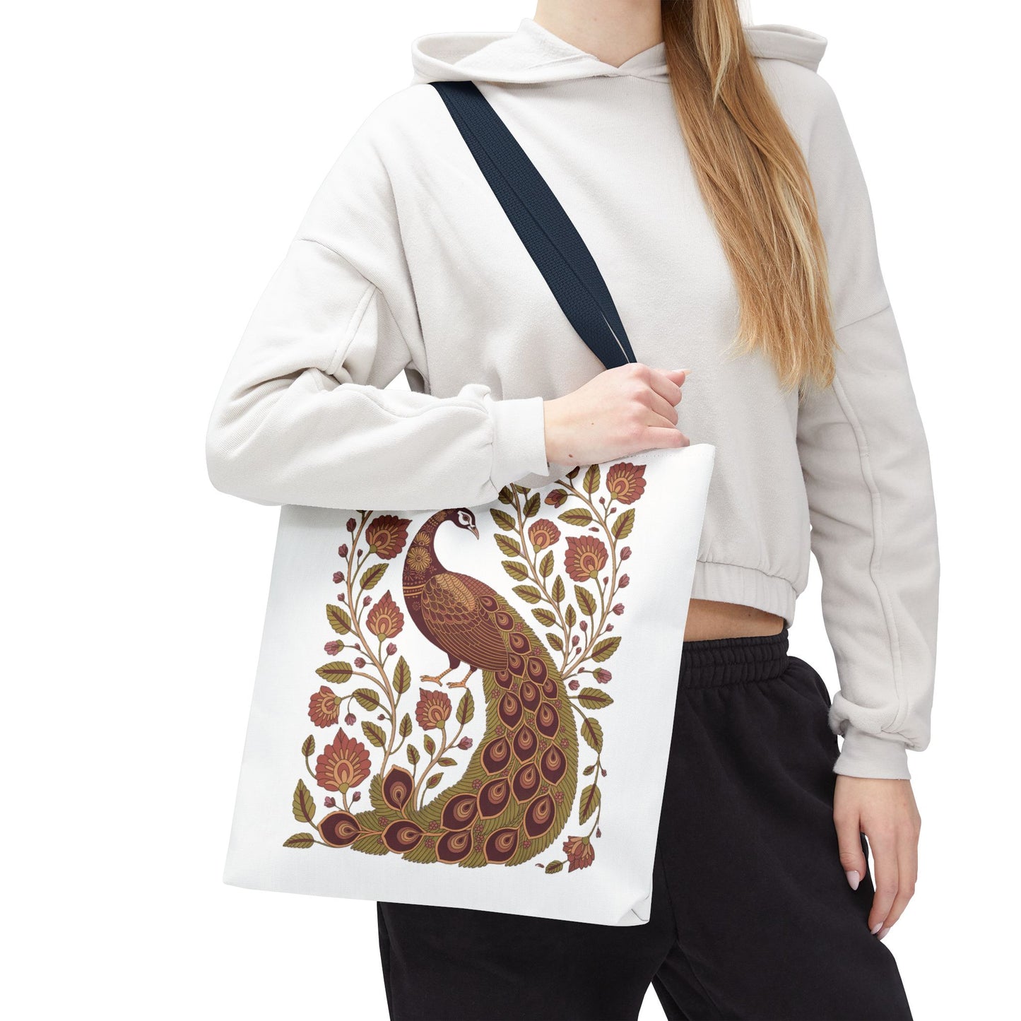 Peacock Tote Bag with Floral Vines and Paisley Motifs held by a woman, showcasing its intricate design of a central peacock amidst floral and paisley patterns, embodying FireBrook Essentials' uplifting and stylish aesthetic.