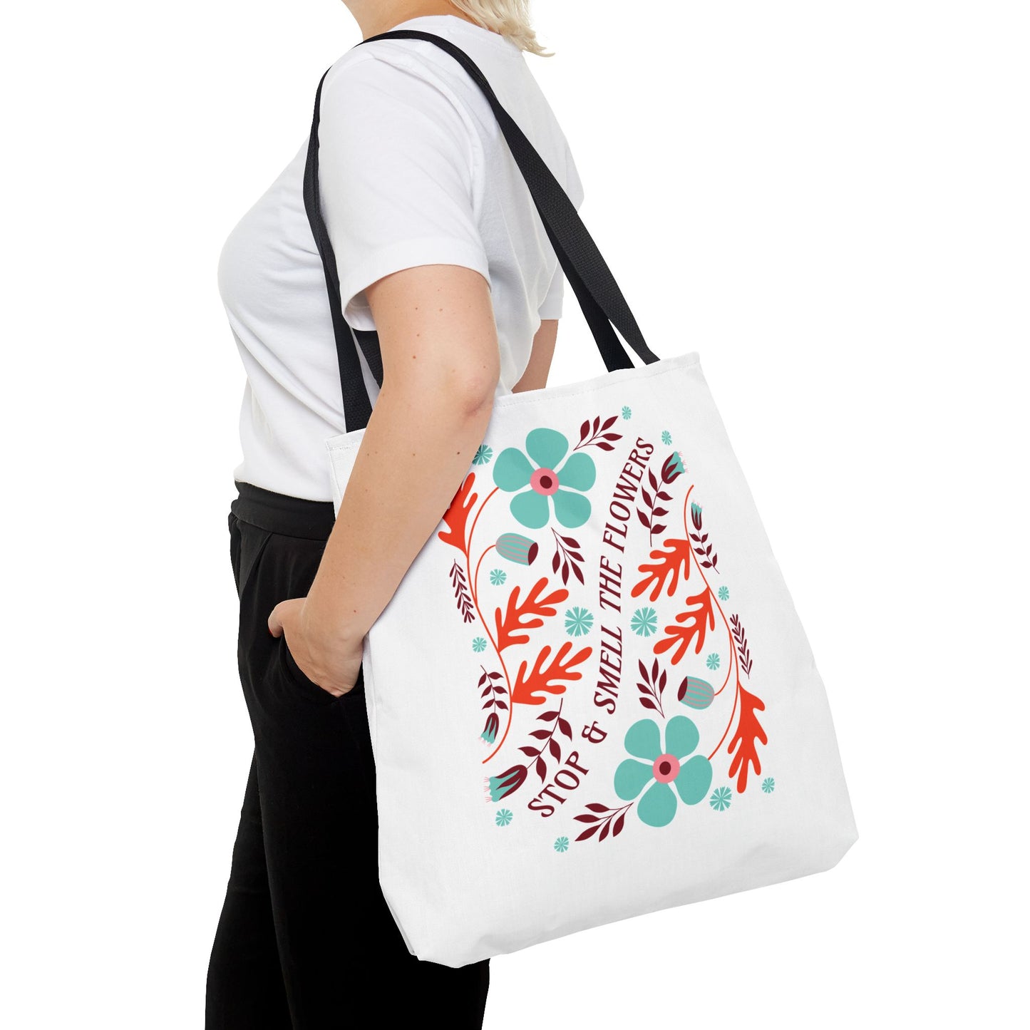 Stop and Smell The Flowers Tote Bag held by a woman, showcasing its nature-inspired design and functionality for carrying essentials.