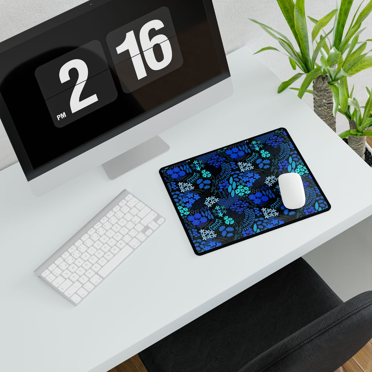 Blue Floral Desk Mat with dark blue and turquoise floral pattern beneath a white wireless mouse, enhancing the minimalist desk setup with a vibrant touch, perfect for elevating any workspace's aesthetic.