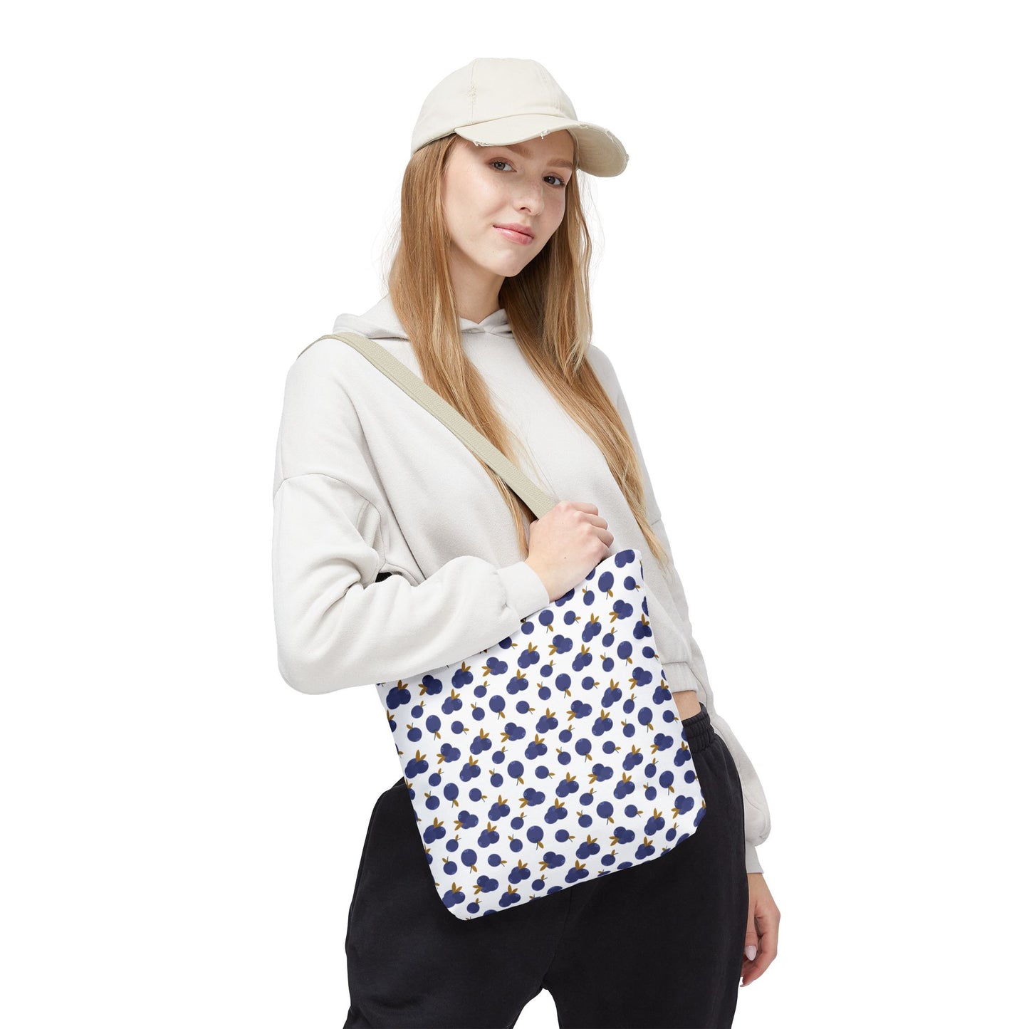 Blueberry Tote Bag with charming blueberry pattern, worn by a woman, showcasing its seamless design, reinforced handles, and spacious boxed corners—perfect for adding stylish functionality to everyday essentials.