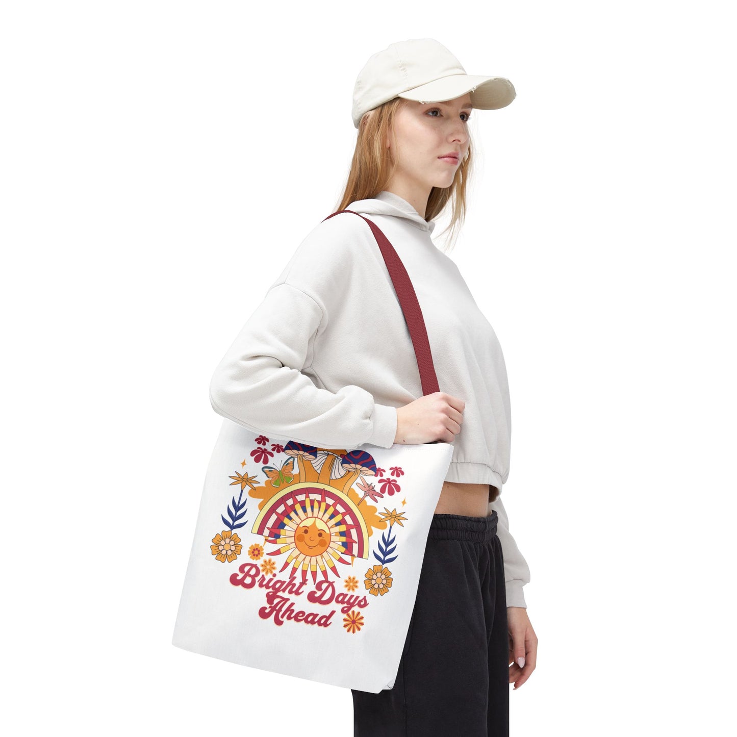 Bright Days Ahead Sunshine Floral Tote Bag features a cheerful design with sunshine, flowers, and butterflies, perfect for beach trips and picnics. Durable polyester body with reinforced handles ensures lasting use.