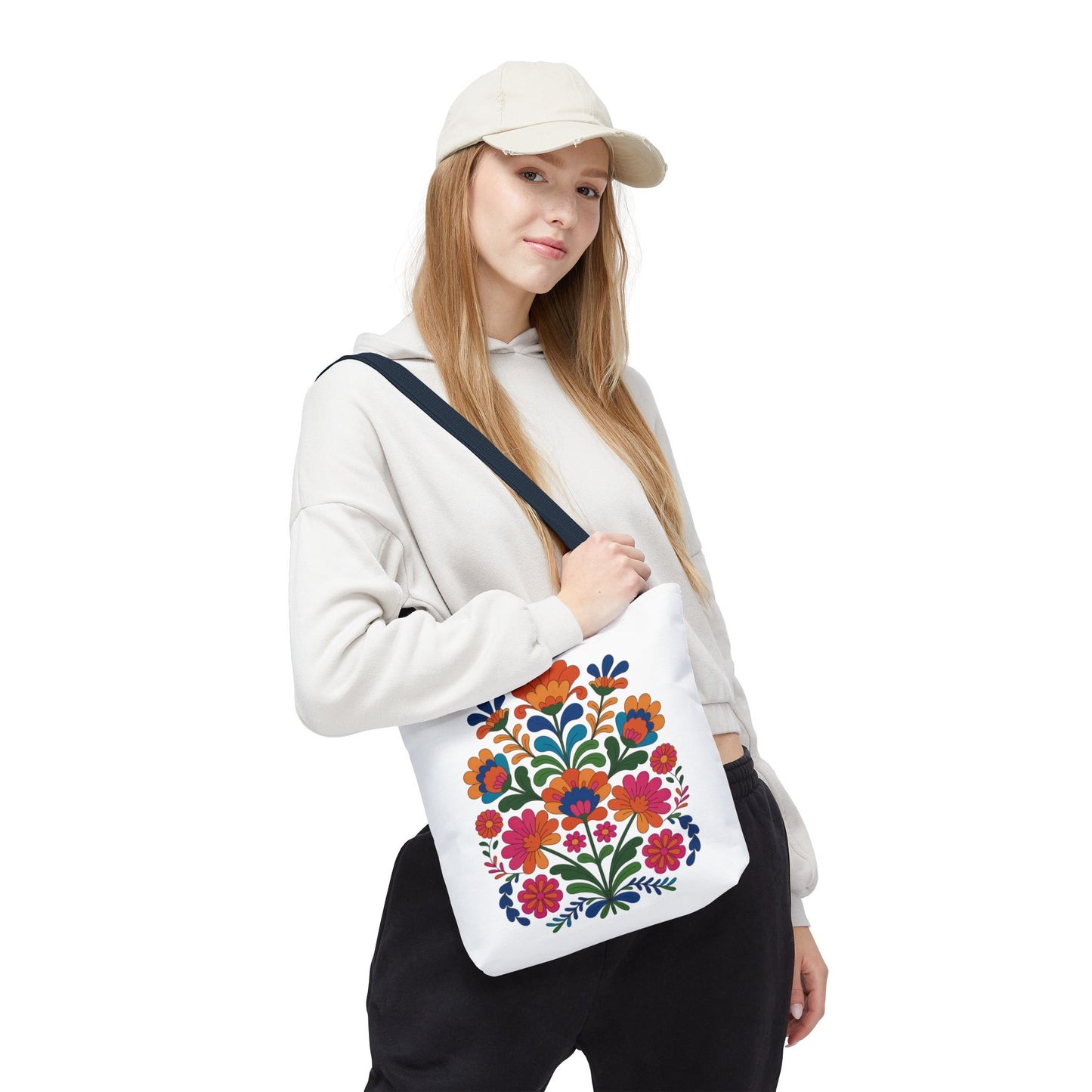 Red Folk-Art Floral Tote Bag featuring vibrant, organic floral illustrations in red tones with green leaves. Made of durable polyester, it's perfect for carrying essentials and adds a joyful, artistic touch to your outings.