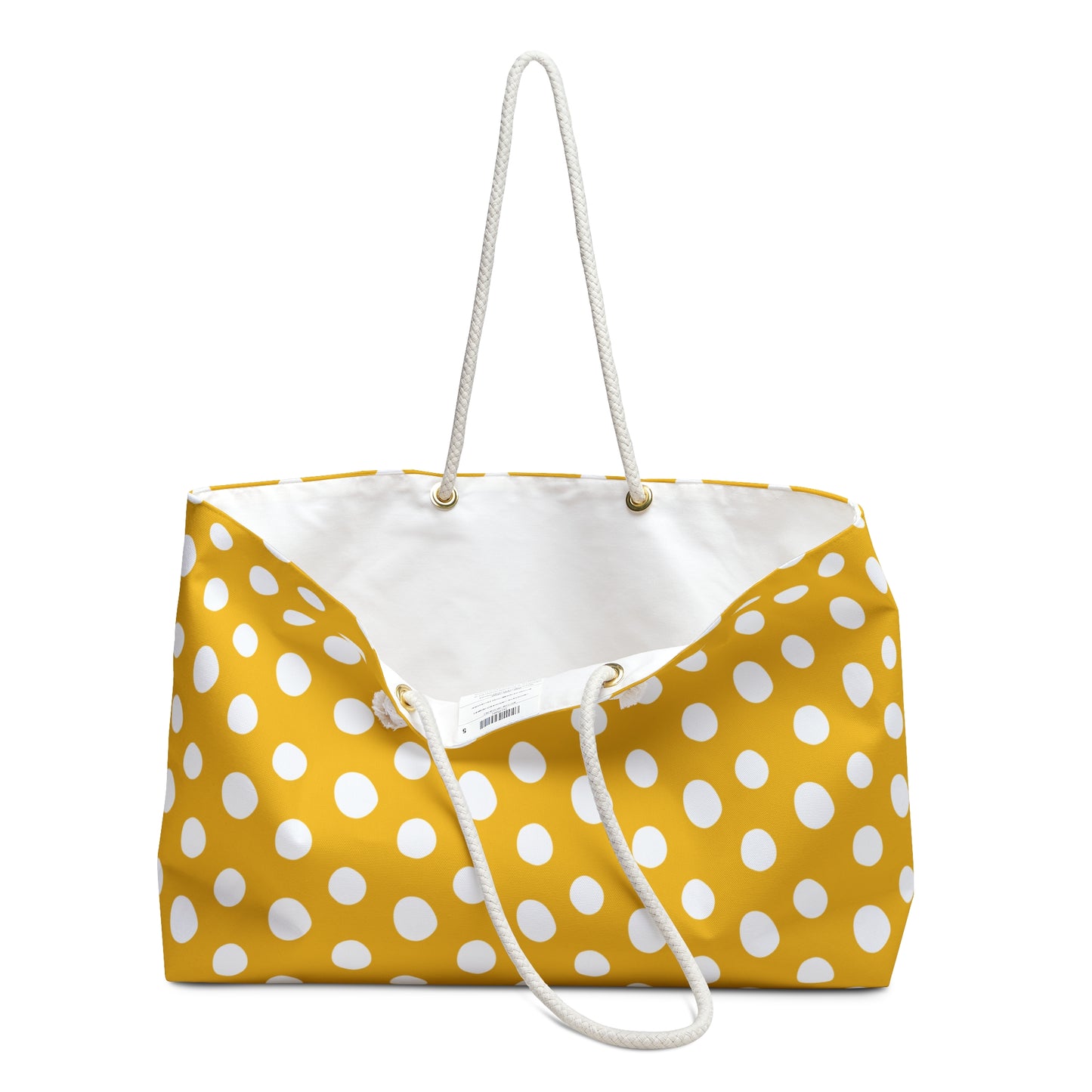 Polka Dot Weekender Bag with yellow and white polka dots, featuring cream-colored rope handles and gold metal grommets, ideal for stylish travelers and weekend adventurers seeking functionality and elegance.
